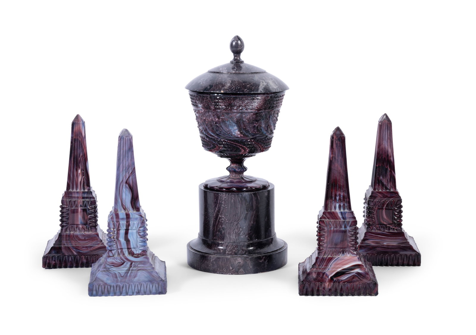 TWO PAIRS OF ENGLISH PRESS-MOULDED 'PURPLE MALACHITE' GLASS OBELISKS, AND A PEDESTAL BOWL ON STAND: A PAIR OF ENGLISH PRESS-MOULDED 'PURPLE MALACHITE' GLASS OBELISKS CIRCA 1880 19.5cm high Together with two other similar examples, a pedestal bowl, 13cm high, and George Oakes painted wood plinth
