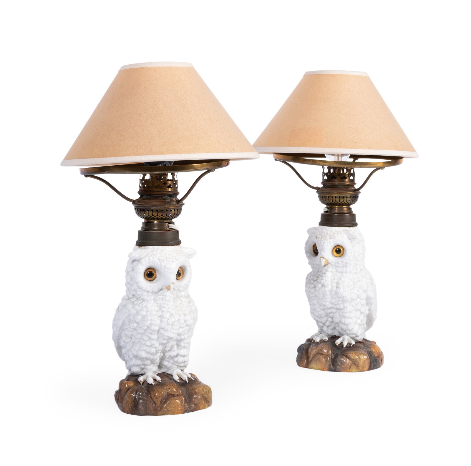A PAIR OF GERMAN PORCELAIN PARAFFIN LAMP BASES MODELLED AS OWLS, LATE 19TH CENTURY: A PAIR OF GERMAN PORCELAIN PARAFFIN LAMP BASES MODELLED AS OWLS WITH GLASS EYES LATE 19TH CENTURY Later converted to electricity 34cm high overall Condition Report: With wear, marks, knocks and