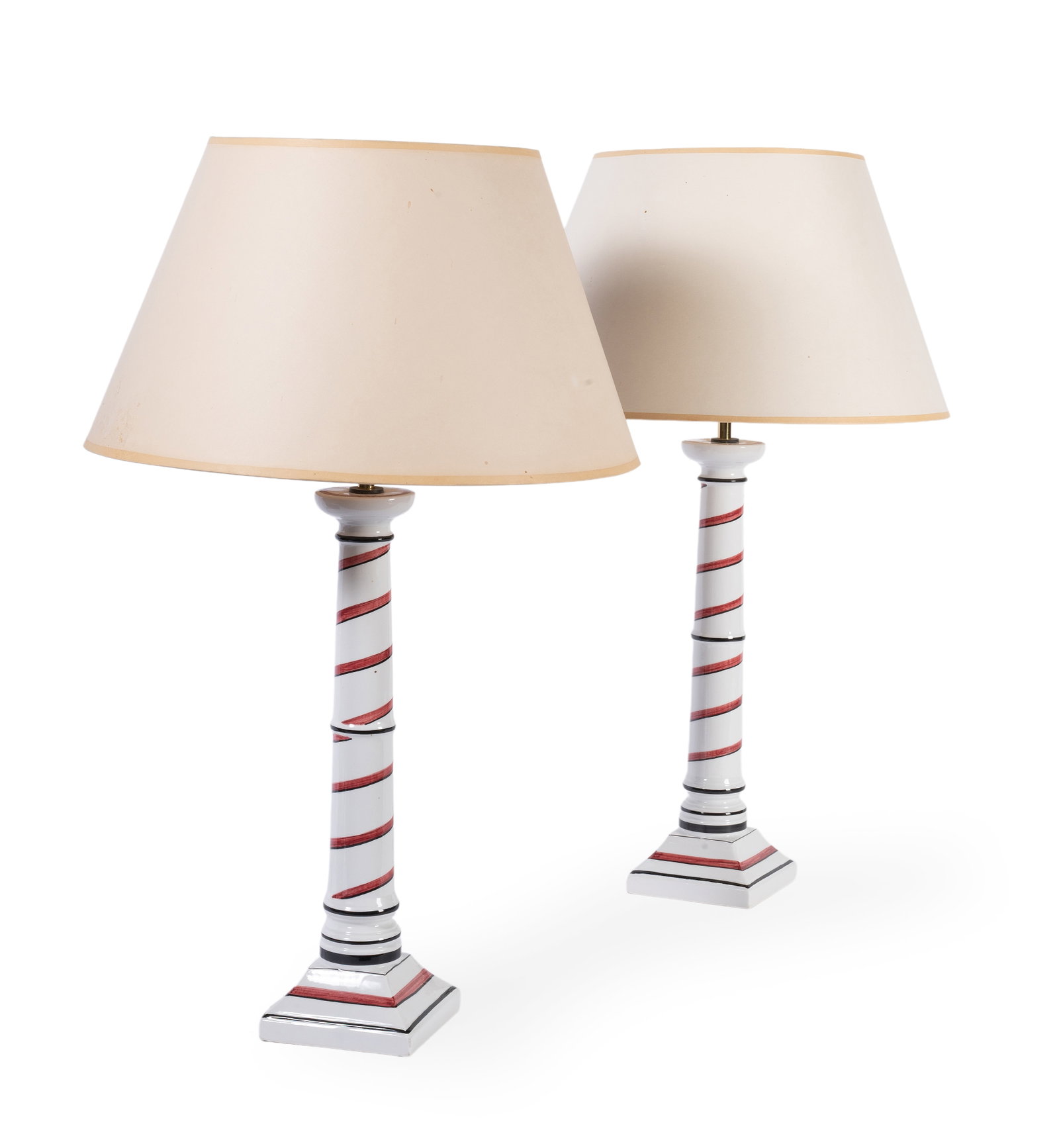 A PAIR OF RED SPIRAL PAINTED CERAMIC TABLE LAMPS, BY SIBYL COLEFAX & JOHN FOWLER, LATE 20TH CENTURY: A PAIR OF RED SPIRAL PAINTED CERAMIC TABLE LAMPS BY SIBYL COLEFAX & JOHN FOWLER, LATE 20TH CENTURY Fitted for electricity, with card shade 68cm high overall, base 12cm square Condition Report: