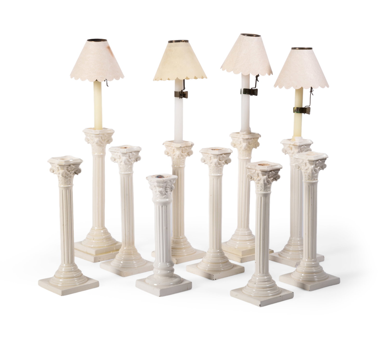 TEN VARIOUS CREAM COLOURED POTTERY COLUMNAR CANDLESTICKS, LATE 19TH CENTURY AND LATER: TEN VARIOUS BRITISH AND CONTINTENTAL CREAM COLOURED POTTERY COLUMNAR CANDLESTICKS LATE 19TH CENTURY AND LATER 32.5cm high and smaller Condition Report Disclaimer