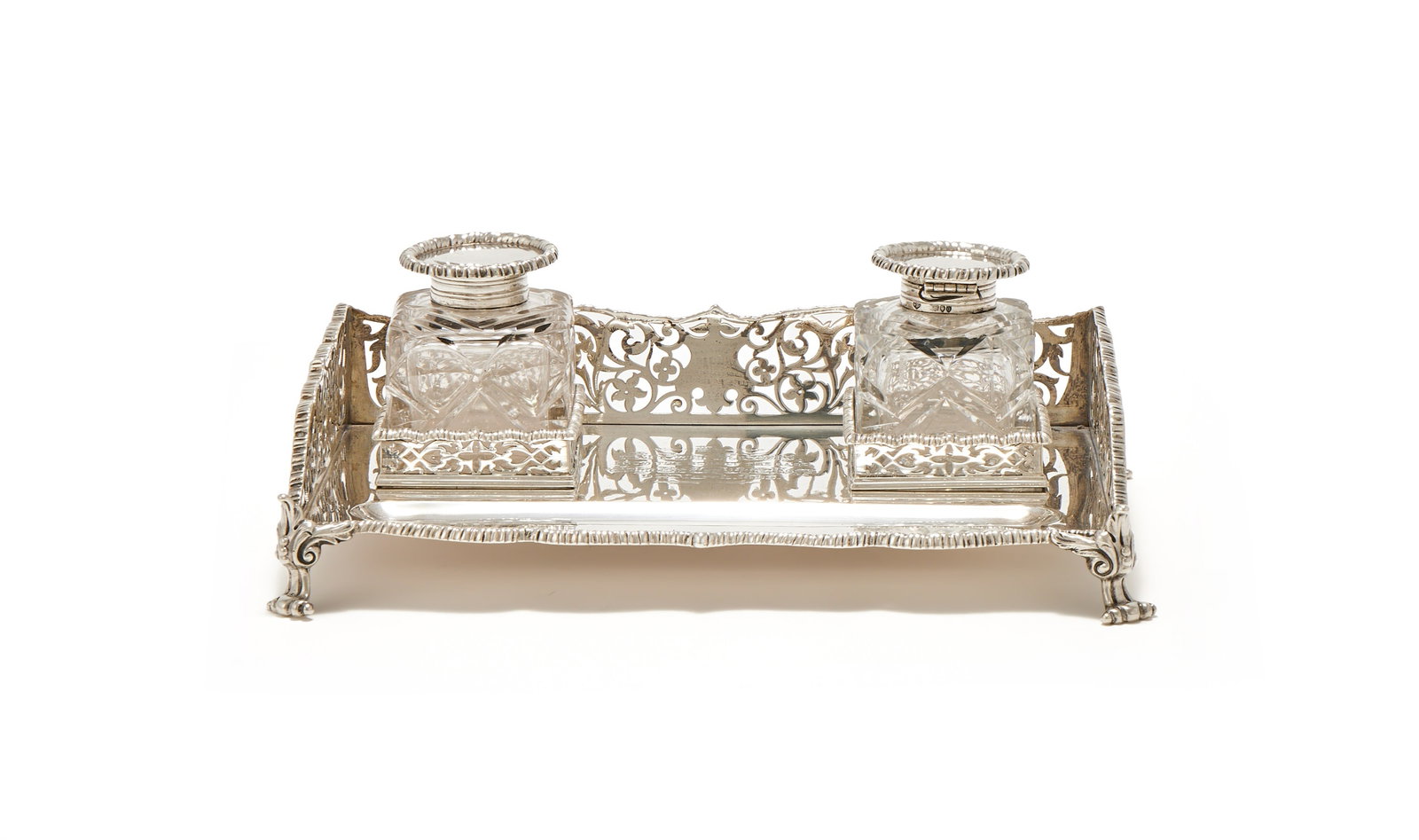 A VICTORIAN SILVER RECTANGULAR TWO BOTTLE INKSTAND, WALTER & JOHN BARNARD, LONDON 1891: A VICTORIAN SILVER RECTANGULAR TWO BOTTLE INKSTANDWALTER & JOHN BARNARD, LONDON 1891With a gadrooned border, pierced foliate scroll gallery, a pen well, two cut glass inkwells with silver covers, engr