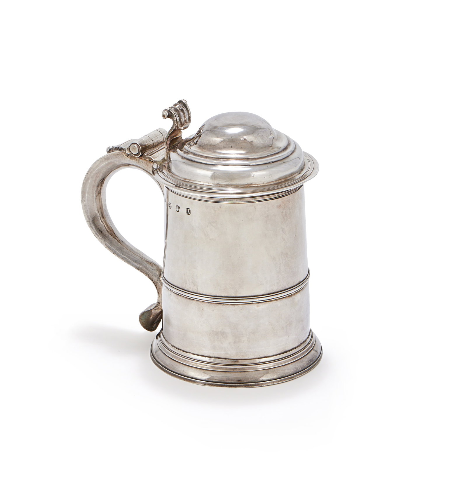A GEORGE II SILVER TANKARD, RICHARD GINES, LONDON 1725: A GEORGE II SILVER TANKARDRICHARD GINES, LONDON 1725With an ogee domed cover, scroll thumb piece and handle, a girdle and engraved W over WM18.5cm high812g (26.1 oz)