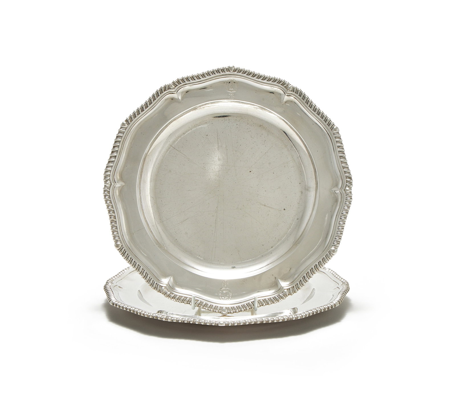 A PAIR OF GEORGE II SILVER CIRCULAR PLATES, JOHN HUGH LE SAGE, LONDON 1744: A PAIR OF GEORGE II SILVER CIRCULAR PLATESJOHN HUGH LE SAGE, LONDON 1744With gadrooned borders and engraved with an armorial29cm diameter1436g (46.15 oz)