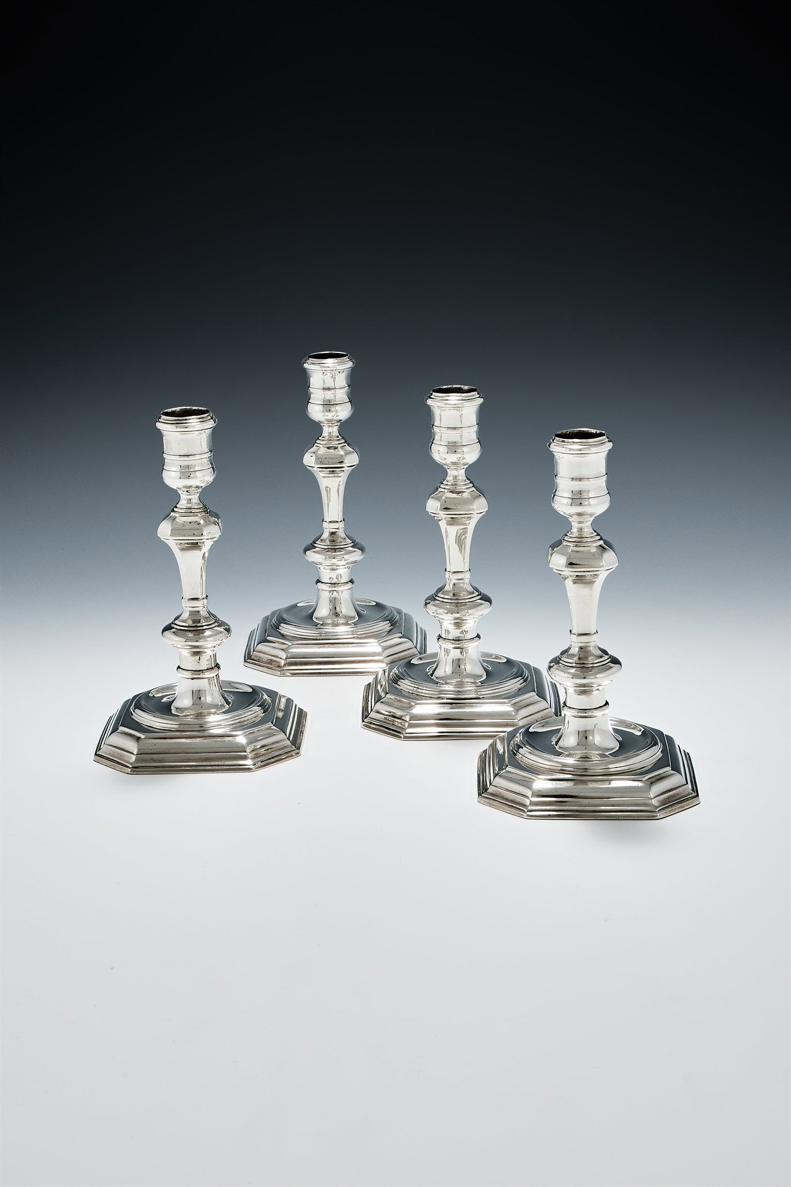 A SET OF FOUR GEORGE I CAST SILVER CANDLESTICKS, SAMUEL MARGAS, LONDON 1724 (1 of 3)