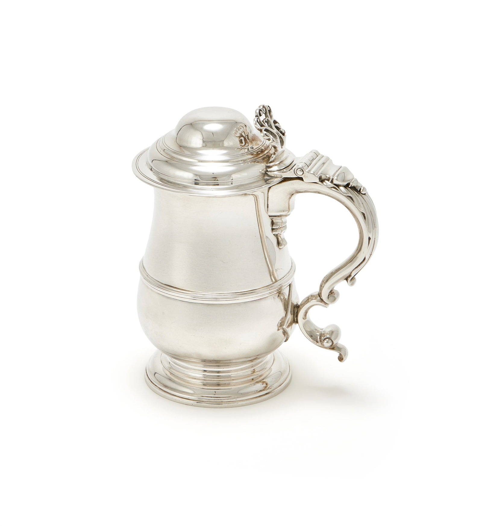 A GEORGE III SILVER BALUSTER TANKARD, PROBABLY BY JOHN SCOFIELD, LONDON 1773: A GEORGE III SILVER BALUSTER TANKARDPROBABLY BY JOHN SCOFIELD, LONDON 1773With a scroll thumb piece to the ogee domed cover, a foliate capped double scroll handle, a girdle, on a circular moulded spre