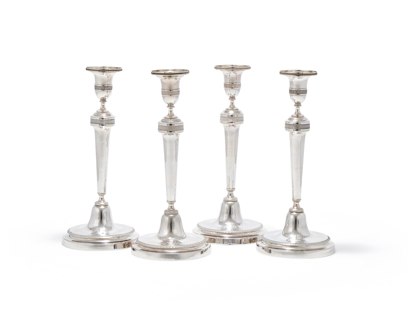 A SET OF FOUR FRENCH EMPIRE SILVER CANDLESTICKS, PARIS, .950 STANDARD, GUARANTEE MARKS 1798 -1809 (1 of 3)
