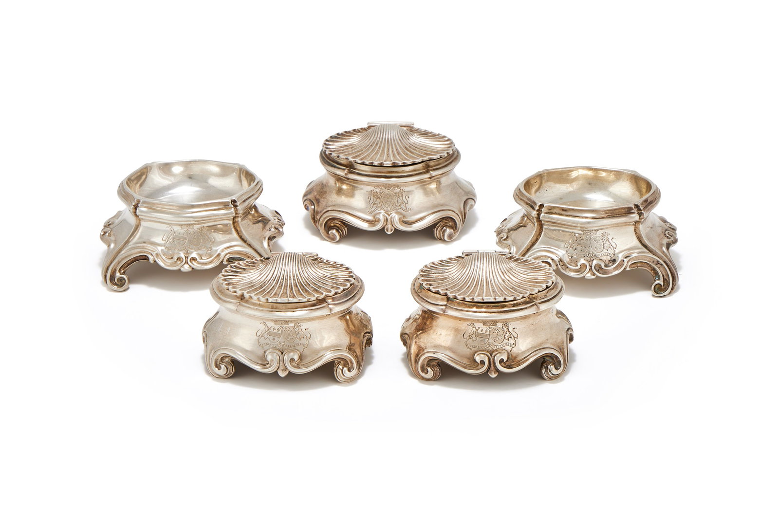 A SET OF FOUR FRENCH SILVER SALTS, 1838 - 1973 .950 STANDARD: A SET OF FOUR FRENCH SILVER SALTS1838 - 1973 .950 STANDARDTwo with shell shaped covers, engraved with armorials and on four scroll feet7 and 8cm longTogether with:A SIMILAR FRENCH SILVER SALTPARIS 175