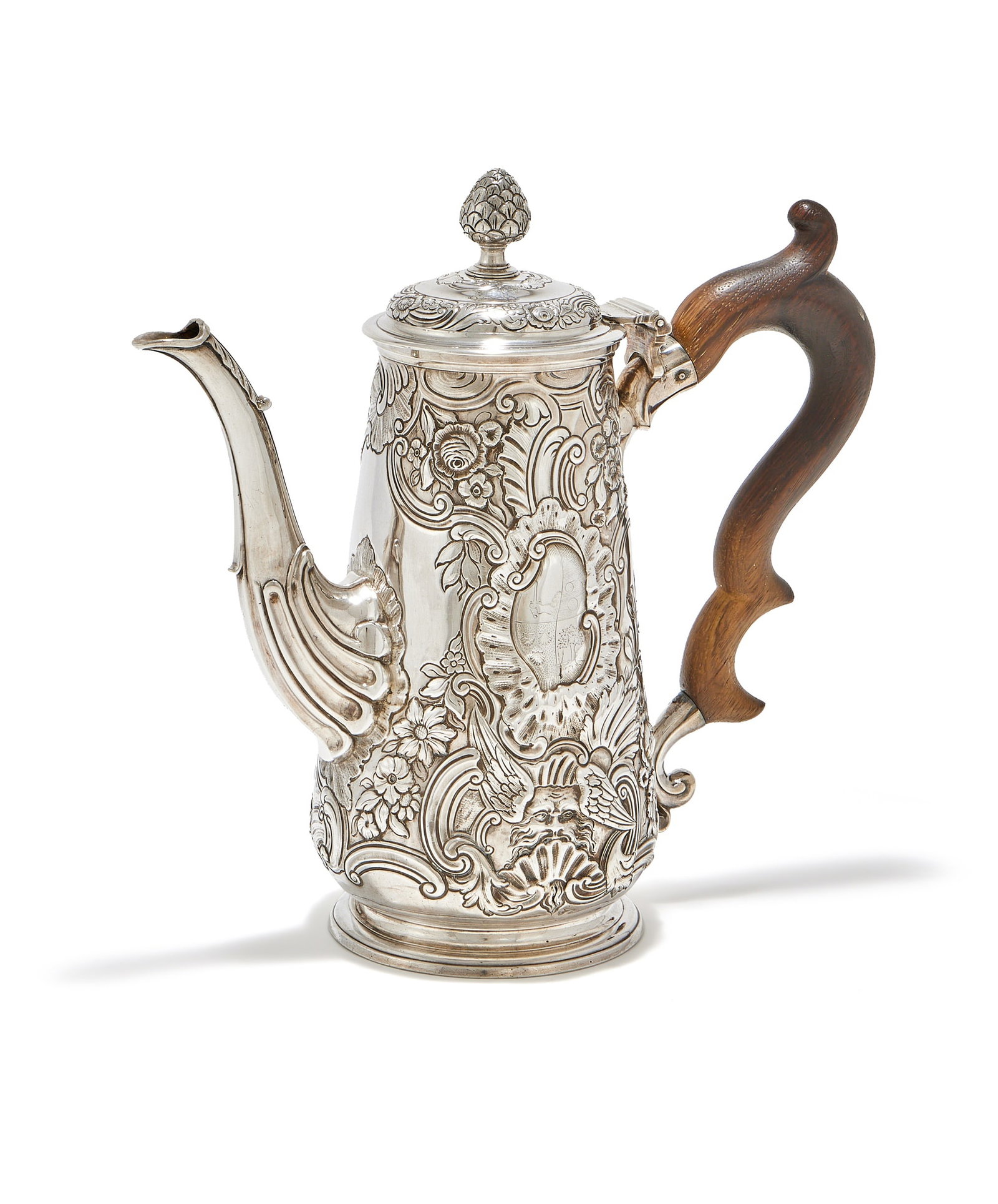 AN IRISH SILVER COFFEE POT, DUBLIN MID 18TH CENTURY, HIBERNIA AND HARP MARKS ONLY: AN IRISH SILVER COFFEE POTDUBLIN MID 18TH CENTURY, HIBERNIA AND HARP MARKS ONLYWith a cone finial to the domed cover, a wood double scroll handle, chased with masks, birds, flowers and foliage, engrav