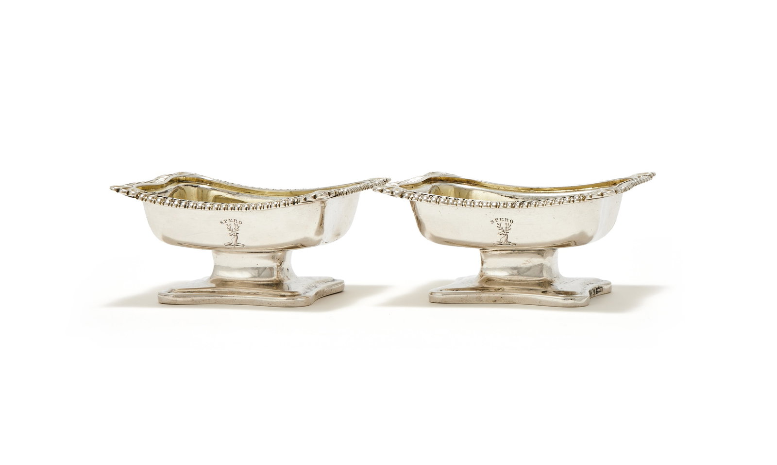 A PAIR OF CHINESE EXPORT SILVER SALT CELLARS, SPURIOUS MARKS, CIRCA 1825: A PAIR OF CHINESE EXPORT SILVER SALT CELLARSSPURIOUS MARKS, CIRCA 1825With gadrooned borders with shells to the corners, engraved with a crest and on shaped oblong pedestal feet9cm long217g (7 oz)
