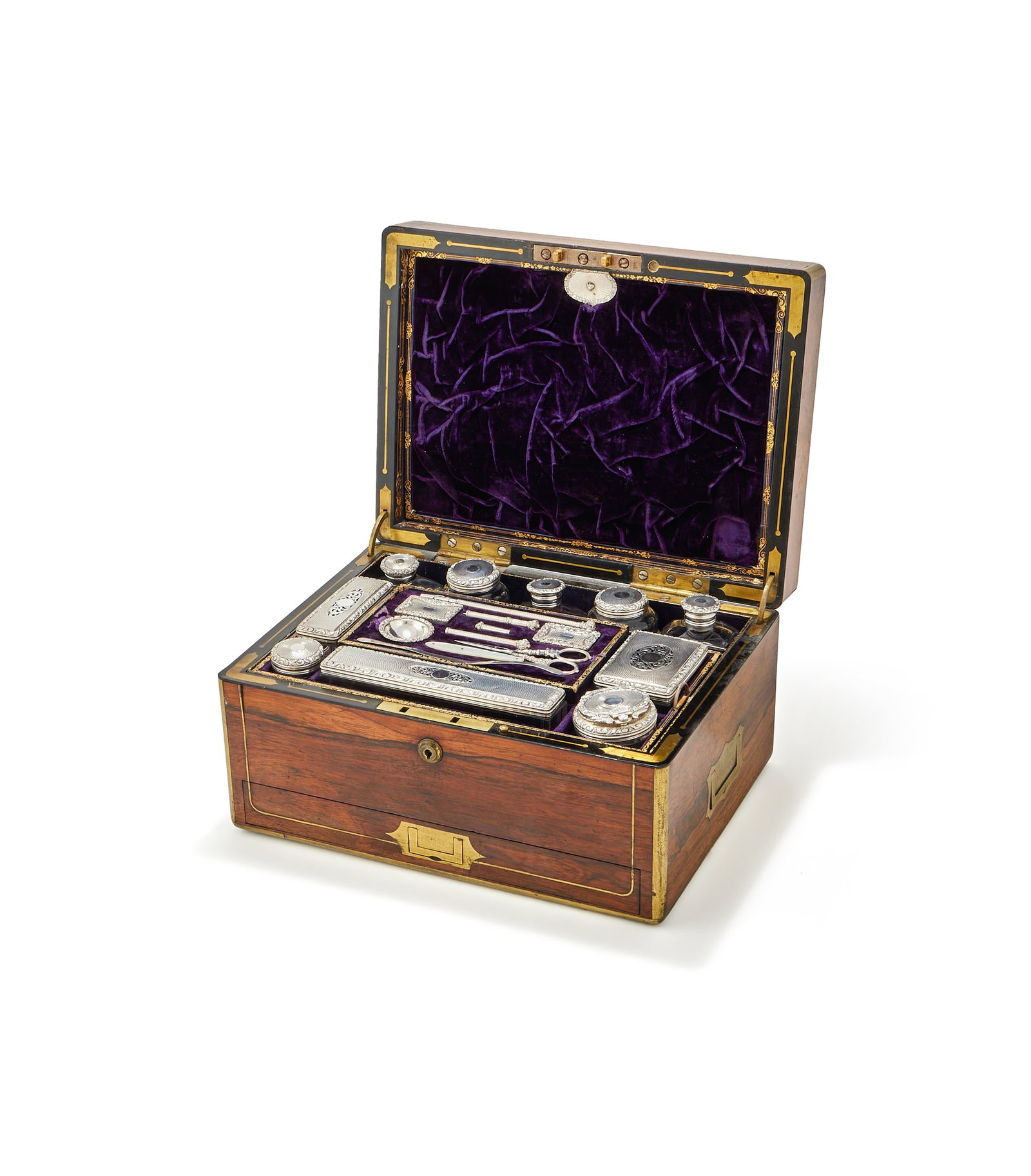 Y A MAHOGANY AND BRASS BOUND TRAVELLING TOILET BOX, CIRCA 1830: Y A MAHOGANY AND BRASS BOUND TRAVELLING TOILET BOXCIRCA 1830With twin inset loop handles and key lock clasp, opening to a purple velvet interior with lift out trays, the cover interior with a slip poc