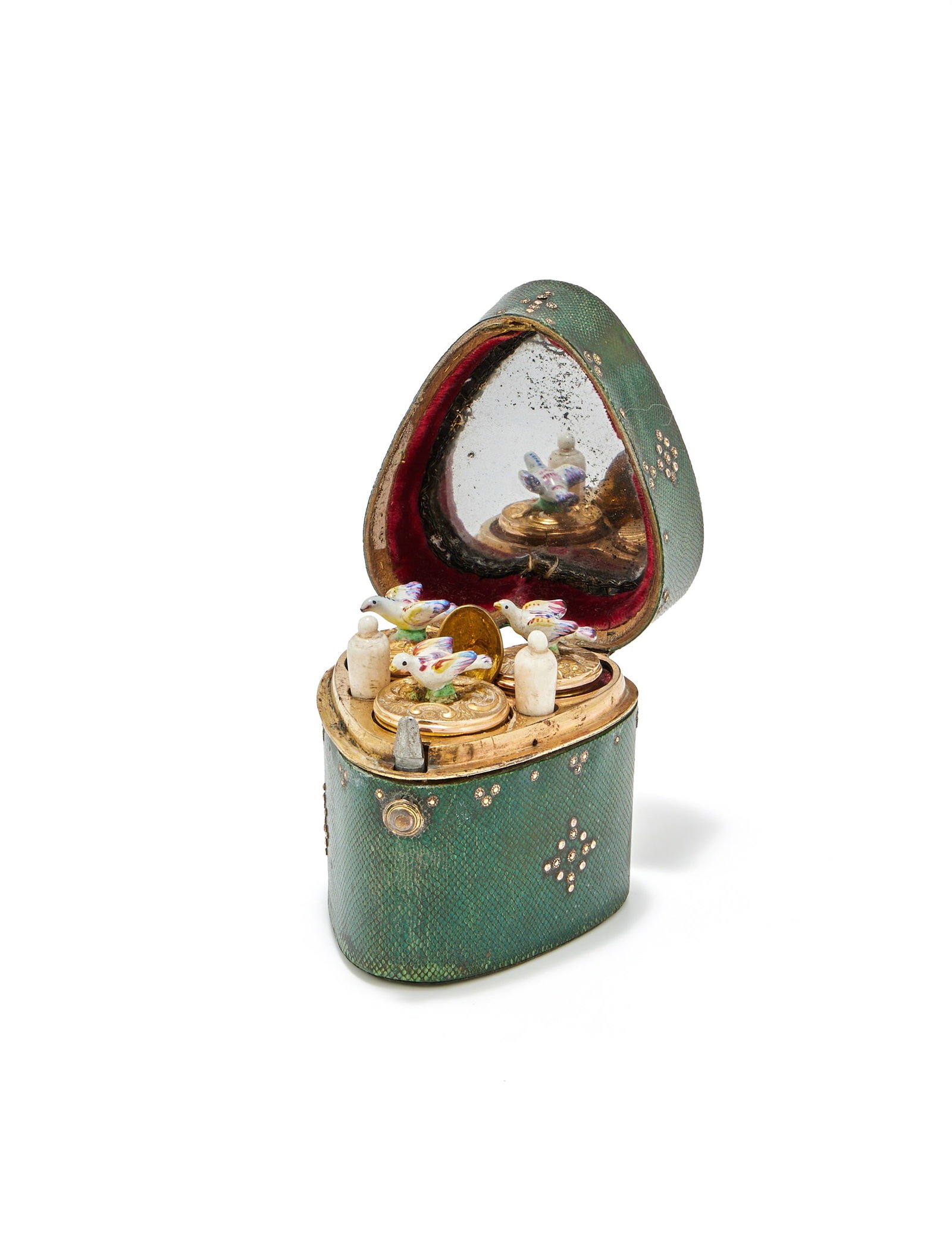 A SHAGREEN AND GILT MOUNTED HEART SHAPED ETUI, UNMARKED, 18TH CENTURY: A SHAGREEN AND GILT MOUNTED HEART SHAPED ETUIUNMARKED, 18TH CENTURYWith stud work decoration, opening to a mirror plate inside the cover, three glass bottles with gilt covers and enamel bird finials, 