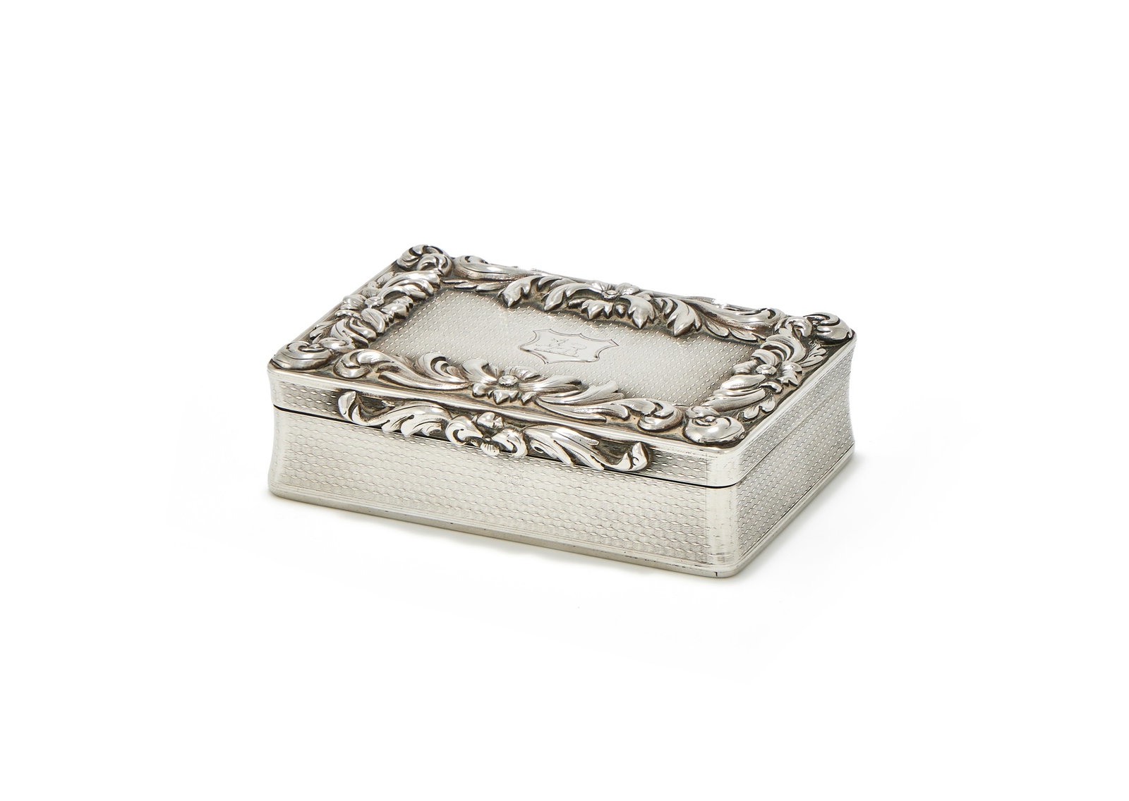 A WILLIAM IV SILVER RECTANGULAR SNUFF BOX, CHARLES RAWLINGS & WILLIAM SUMMERS, LONDON 1834: A WILLIAM IV SILVER RECTANGULAR SNUFF BOXCHARLES RAWLINGS & WILLIAM SUMMERS, LONDON 1834With engine turned decoration, a chased foliate swag border and thumb piece, the cover engraved with a crest wit