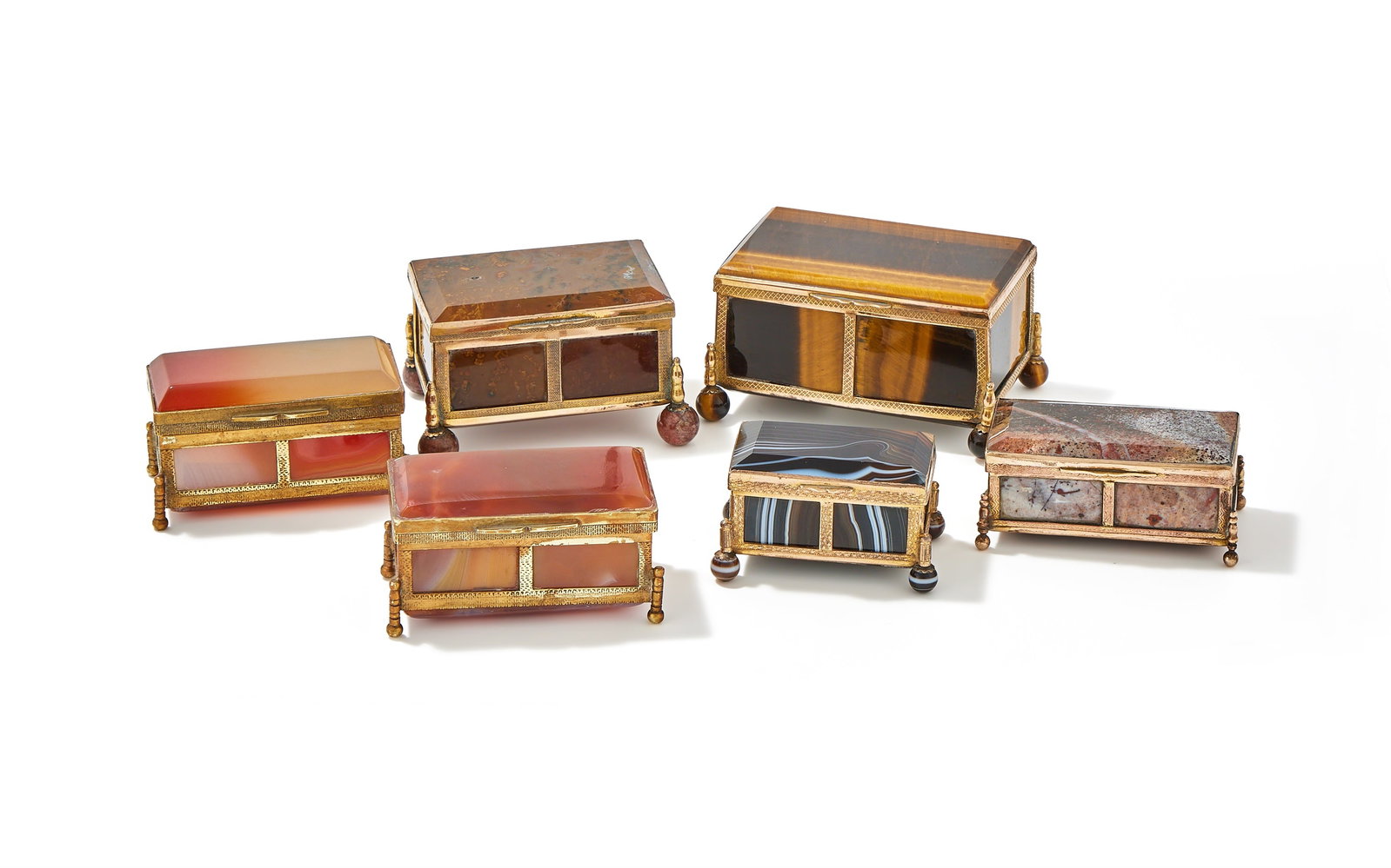 A GROUP OF SIX GILT METAL AND MOUNTED AGATE BOXES, FRENCH OR GERMAN, LATE 19TH CENTURY: A GROUP OF SIX GILT METAL AND MOUNTED AGATE BOXESFRENCH OR GERMAN, LATE 19TH CENTURYComprising:A TIGER'S EYE BOXWith gilt metal mounts and ball feet8cm longA MOSS JASPER BOXWith gilt metal mounts and 