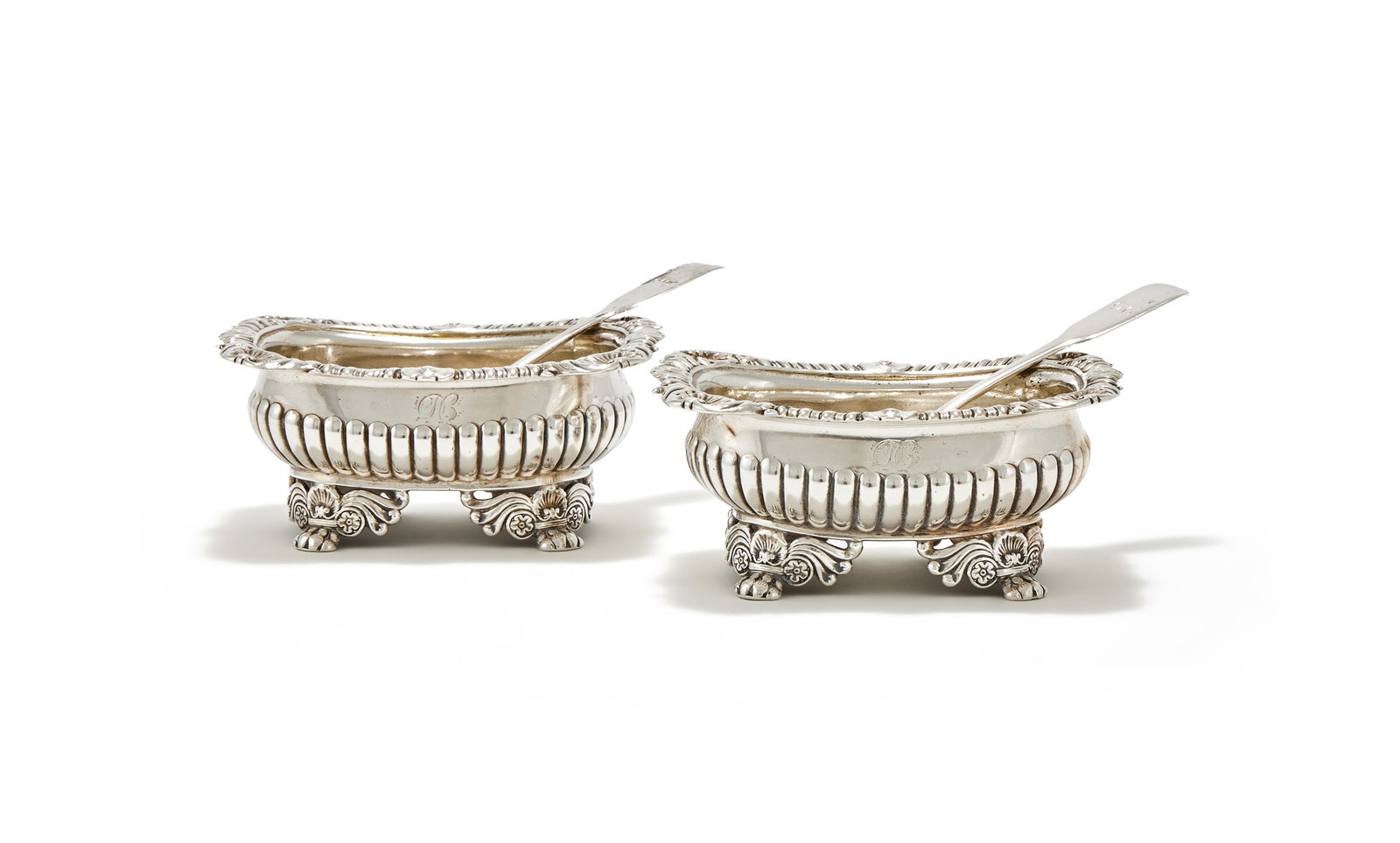 A PAIR OF GEORGE III SILVER OBLONG SALTS, MAKER'S MARK ... F, LONDON 1818 AND 1819: A PAIR OF GEORGE III SILVER OBLONG SALTSMAKER'S MARK ... F, LONDON 1818 AND 1819The gadrooned borders with shells at intervals, the half lobed bodies engraved with a monogram and on four scroll, shell
