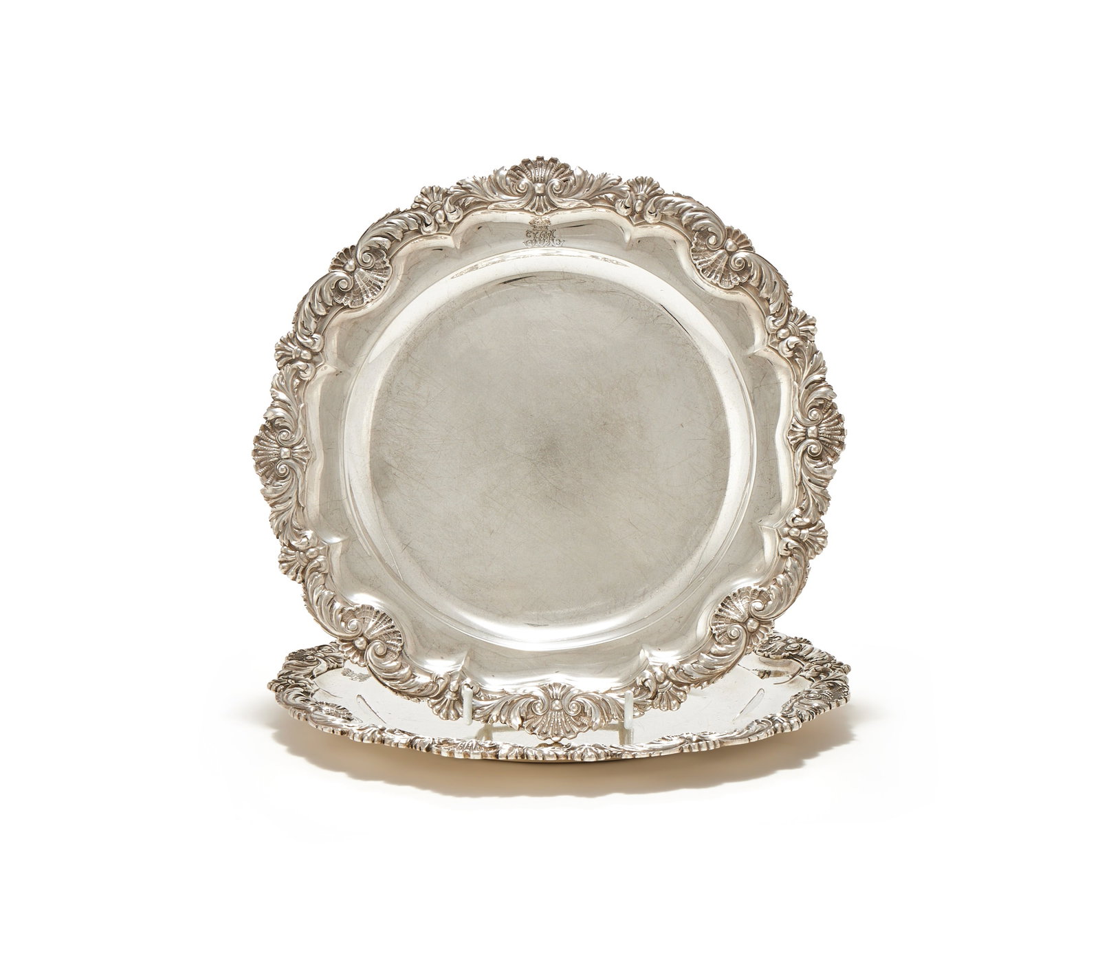 A PAIR OF GEORGE III SILVER SHAPED CIRCULAR PLATES, PAUL STORR, LONDON 1818: A PAIR OF GEORGE III SILVER SHAPED CIRCULAR PLATESPAUL STORR, LONDON 1818With foliate and shell borders, engraved with a coronet above H ST A, the reverse with a crest26.5cm diameter1560g (50.15