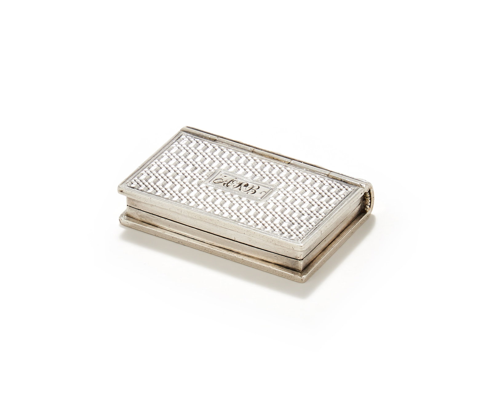 A WILLIAM IV SILVER NOVELTY BOOK VINAIGRETTE, TAYLOR & PERRY, BIRMINGHAM 1833: A WILLIAM IV SILVER NOVELTY BOOK VINAIGRETTETAYLOR & PERRY, BIRMINGHAM 1833With engine turned decoration and engraved APB within a rectangular reserve, opening to a gilt pierced and engraved foliate