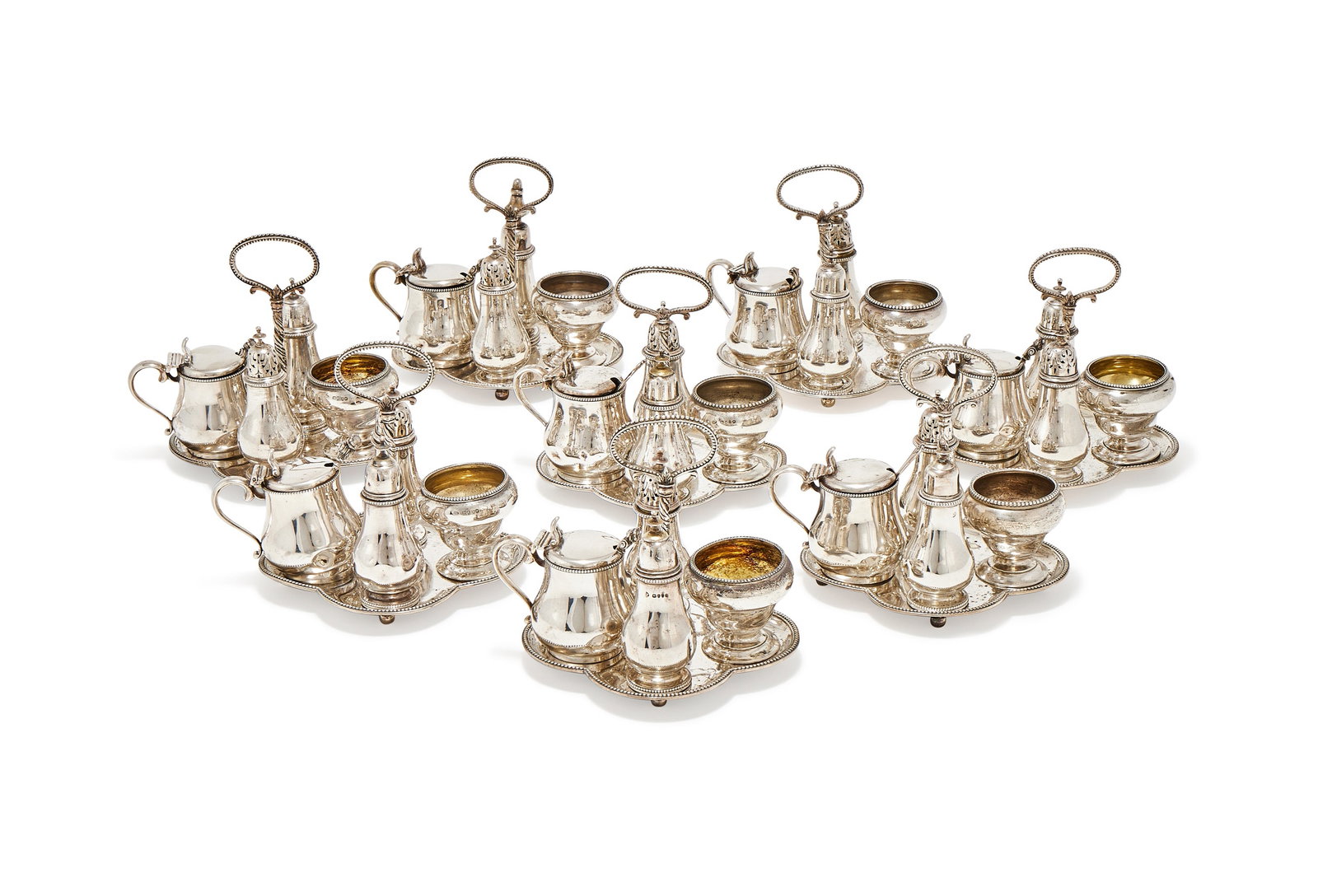 A MATCHED SET OF EIGHT VICTORIAN SILVER FOUR PIECE CRUETS ON STANDS, LONDON 1868 AND 1877: A MATCHED SET OF EIGHT VICTORIAN SILVER FOUR PIECE CRUETS ON STANDSGEORGE FOX, LONDON 1868 (4) AND 1877 (4)Each comprising of a baluster mustard, pepperette, salt and cayenne pepper with spoon, the qu