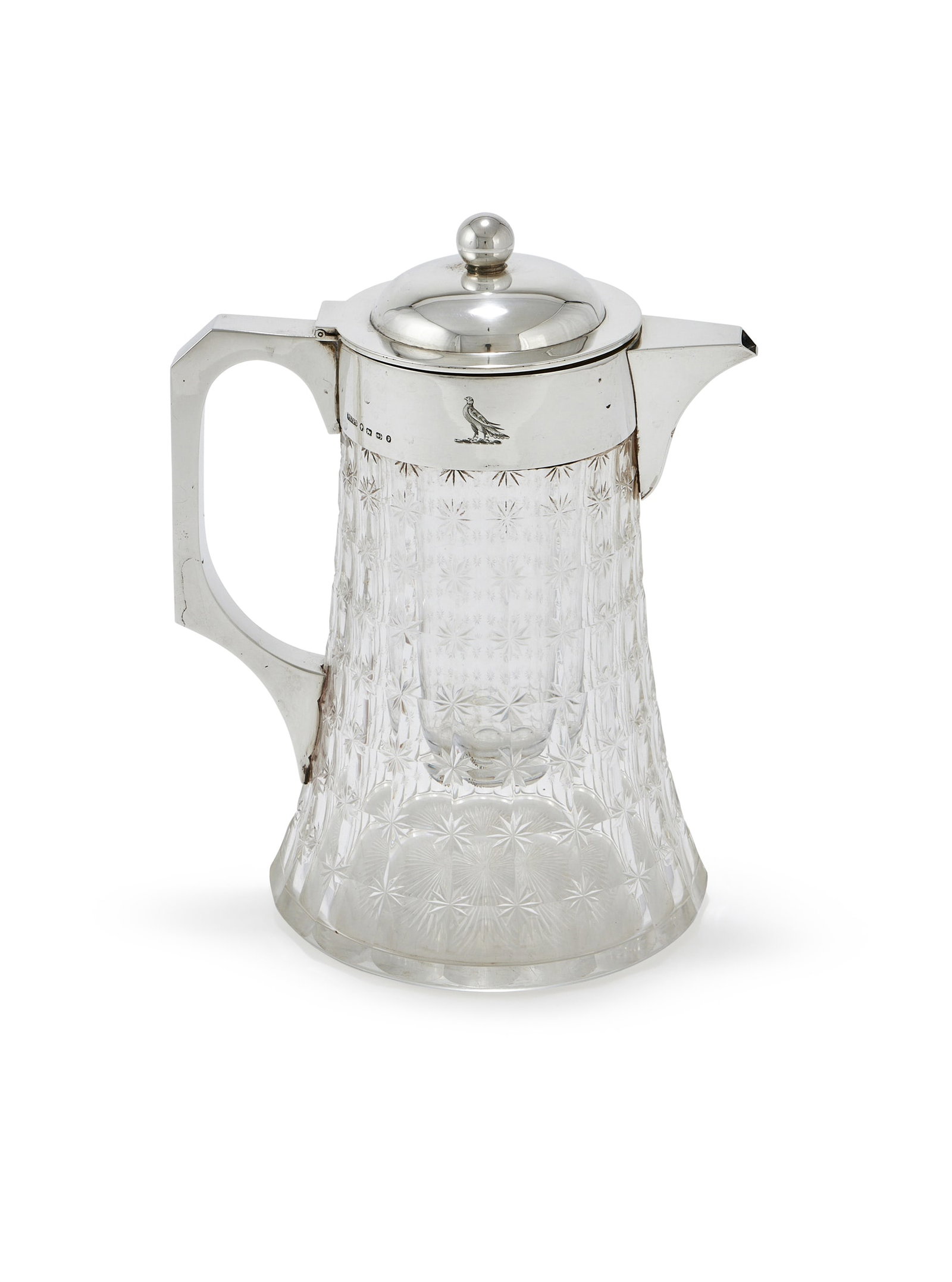 A VICTORIAN SILVER MOUNTED AND CUT LEMONADE JUG, JOHN GRINSELL & SONS, BIRMINGHAM 1890: A VICTORIAN SILVER MOUNTED AND CUT LEMONADE JUGJOHN GRINSELL & SONS, BIRMINGHAM 1890With a ball finial to the domed cover, a loop handle and engraved with a crest24cm high