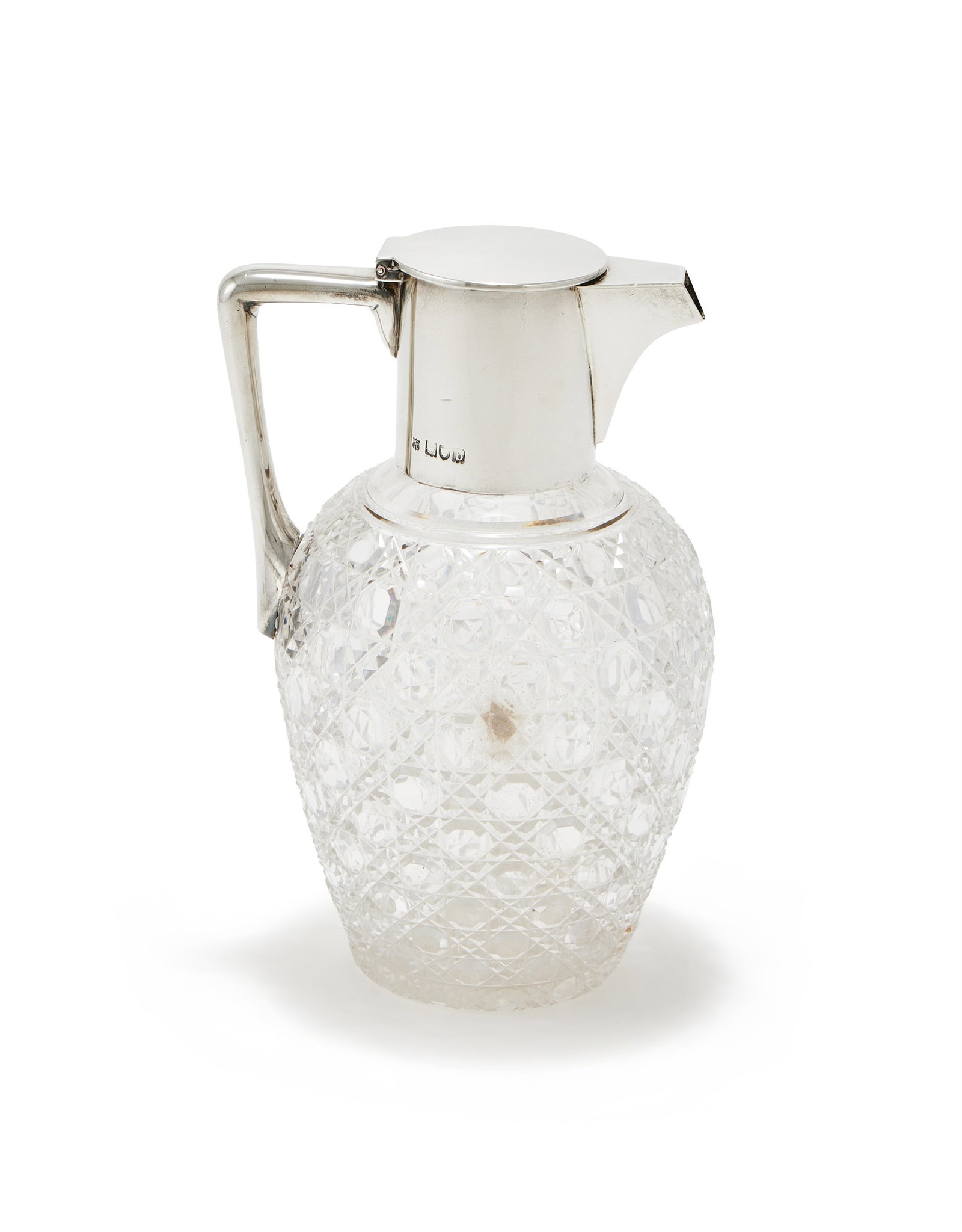 A VICTORIAN SILVER MOUNTED AND CUT GLASS CLARET JUG, GOLDSMITHS & SILVERSMITHS CO., LONDON 1897: A VICTORIAN SILVER MOUNTED AND CUT GLASS CLARET JUGGOLDSMITHS & SILVERSMITHS CO. (WILLIAM GIBSON & JOHN LAWRENCE LANGMAN), LONDON 1897With a flat cover and angular handle20cm high