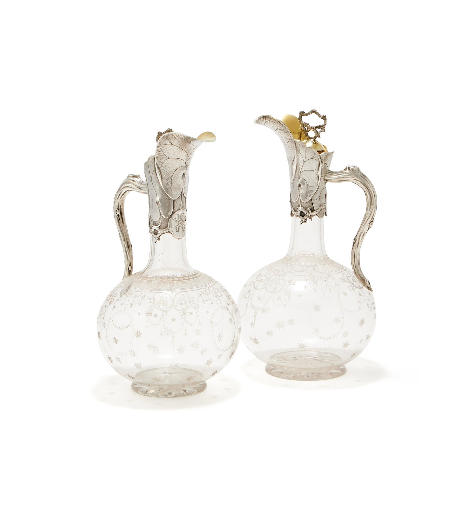 A PAIR OF VICTORIAN SILVER MOUNTED AND GLASS CLARET JUGS, GEORGE FOX, LONDON 1866: A PAIR OF VICTORIAN SILVER MOUNTED AND GLASS CLARET JUGSGEORGE FOX, LONDON 1866With scrolled loop handles to the stoppers, the mounts chased and engraved with leaves, branch scroll handles and engrave
