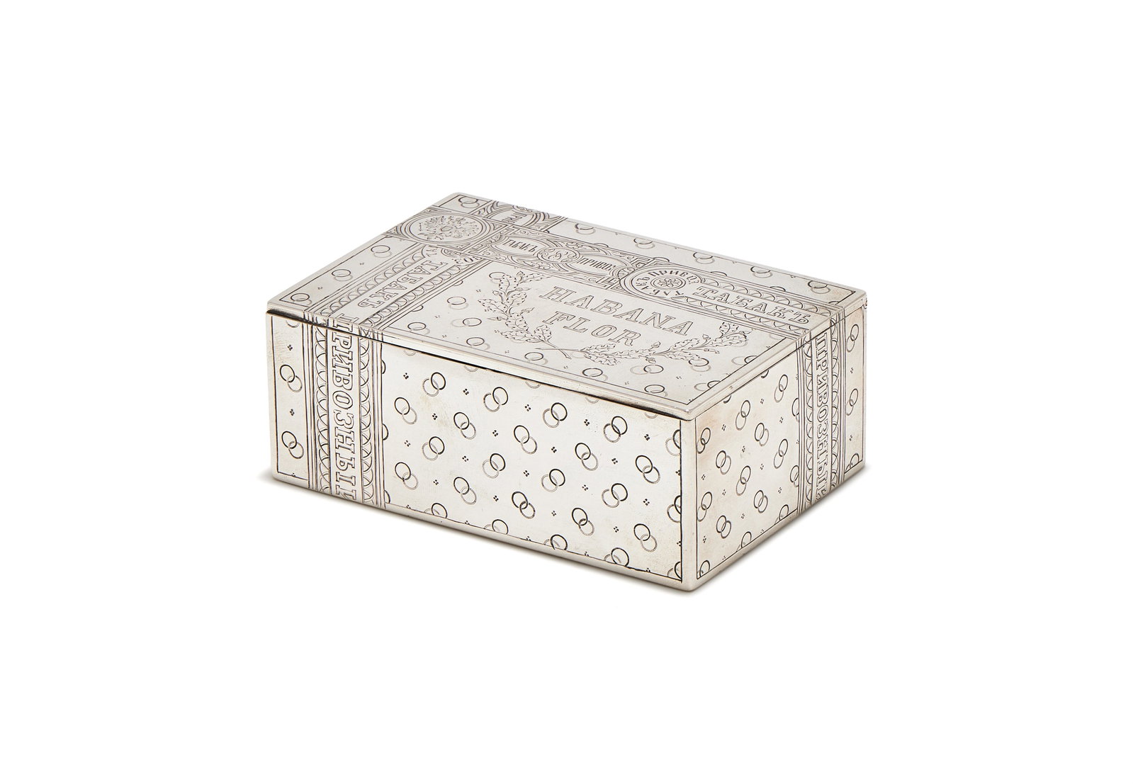 A RUSSIAN SILVER TROMPE L'OEIL CIGAR BOX, MAKER'S MARK AE, MOSCOW 1893: A RUSSIAN SILVER TROMPE L'OEIL CIGAR BOXMAKER'S MARK AE, MOSCOW 1893Engraved to simulate a cigar box with Habana Flor within an oak leaf and acorn wreath, tax bands and a linked circles pattern11.5cm 