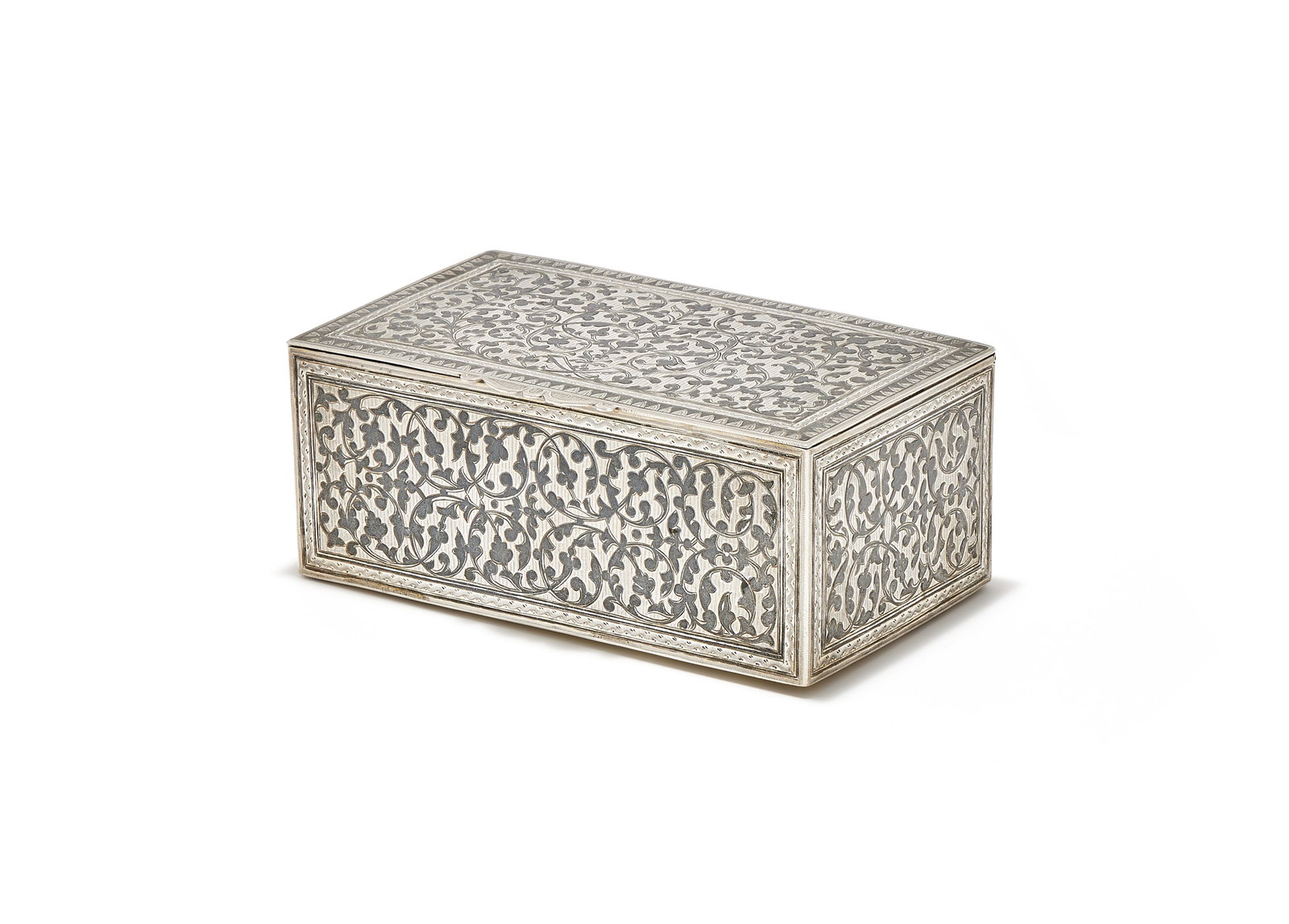 A SILVER AND NIELLO RECTANGULAR TABLE BOX, POSSIBLY CAUCASUS OR CENTRAL ASIA, UNMARKED: A SILVER AND NIELLO RECTANGULAR TABLE BOXPOSSIBLY CAUCASUS OR CENTRAL ASIA, UNMARKEDWith foliate swag decoration16cm long478g (15.35 oz)Provenance:Sale, Helios Auctions New York, Russian & European De