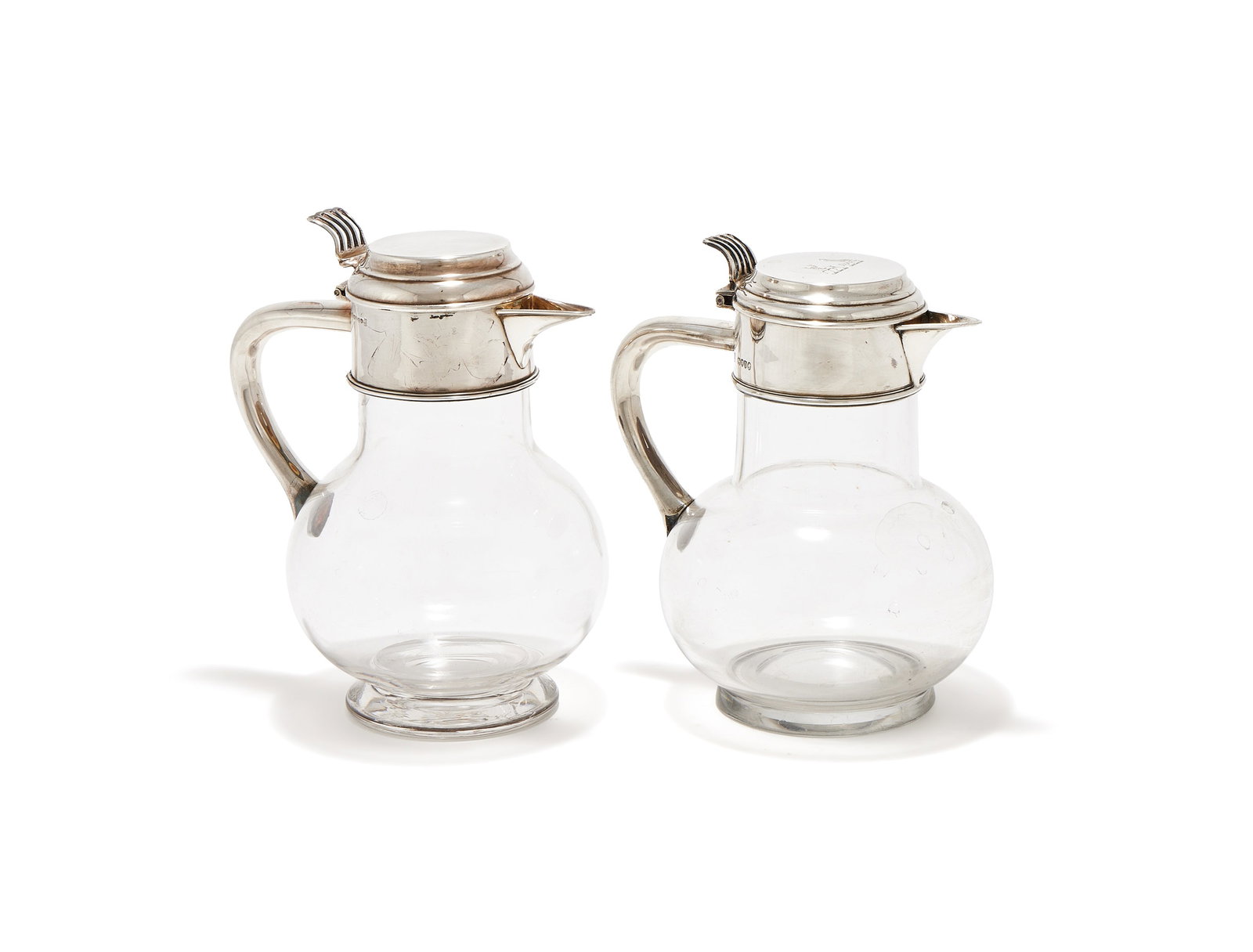 A VICTORIAN SILVER MOUNTED AND GLASS CLARET JUG, RICHARD HODD & SON, LONDON 1879: A VICTORIAN SILVER MOUNTED AND GLASS CLARET JUGRICHARD HODD & SON, LONDON 1879With a domed cover, pierced thumb piece, engraved with two crests and angular handle18cm highTogether with:A SIMILAR ELECT