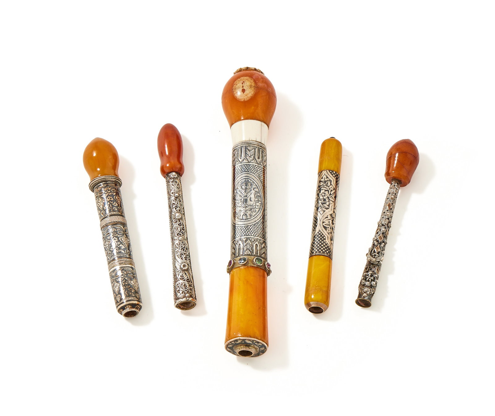 Y FIVE OTTOMAN CIGARETTE HOLDERS, TURKEY , 19TH CENTURY: Y FIVE OTTOMAN CIGARETTE HOLDERS TURKEY, 19TH CENTURYComprising:A SILVER NIELLO, PRESSED AMBER AND IVORY CIGARETTE HOLDERUNMARKEDWith chequered and floral decoration, inset with a band of turquoise an