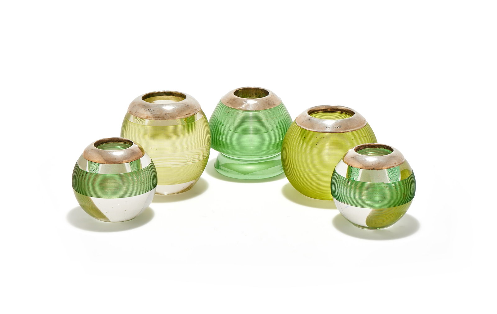 FIVE SILVER MOUNTED AND GREEN GLASS MATCH STRIKERS, VARIOUS MAKERS AND DATES: FIVE SILVER MOUNTED AND GREEN GLASS MATCH STRIKERSVARIOUS MAKERS AND DATESWith silver polished rims, comprising:A VICTORIAN SILVER MOUNTED AND GREEN GLASS MATCH STRIKERROBERT PRINGLE & SONS, LONDON 18