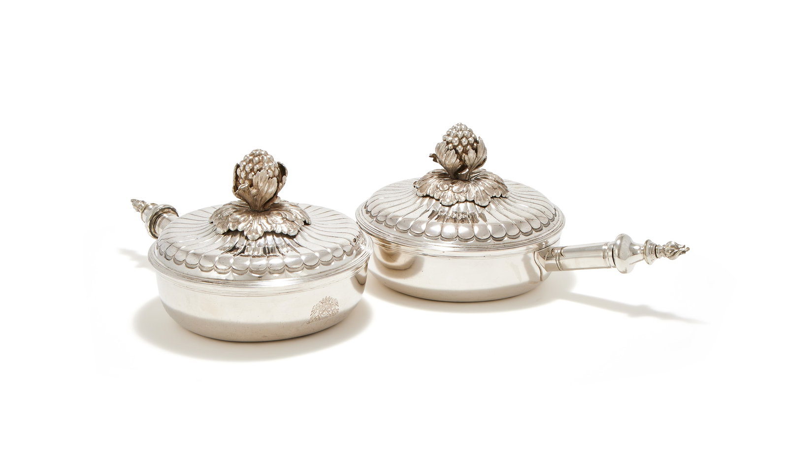 A PAIR OF 19TH CENTURY DUTCH SILVER SERVING PANS, APPARENT MARKS FOR THE HAGUE, 1845: A PAIR OF 19TH CENTURY DUTCH SILVER SERVING PANSAPPARENT MARKS FOR THE HAGUE, 1845With floral finials to the lobed domed covers, the handles with associated white metal flame terminals37cm long3463g (