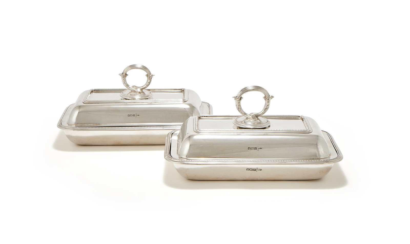 A PAIR OF EDWARDIAN SILVER OBLONG ENTRÉE DISHES, COVERS AND HANDLES, WALKER & HALL, SHEFFIELD: A PAIR OF EDWARDIAN SILVER OBLONG ENTRÉE DISHES, COVERS AND HANDLESWALKER & HALL, SHEFFIELD 1904With reeded loop handles and beaded borders25cm long2367g (76.1 oz)