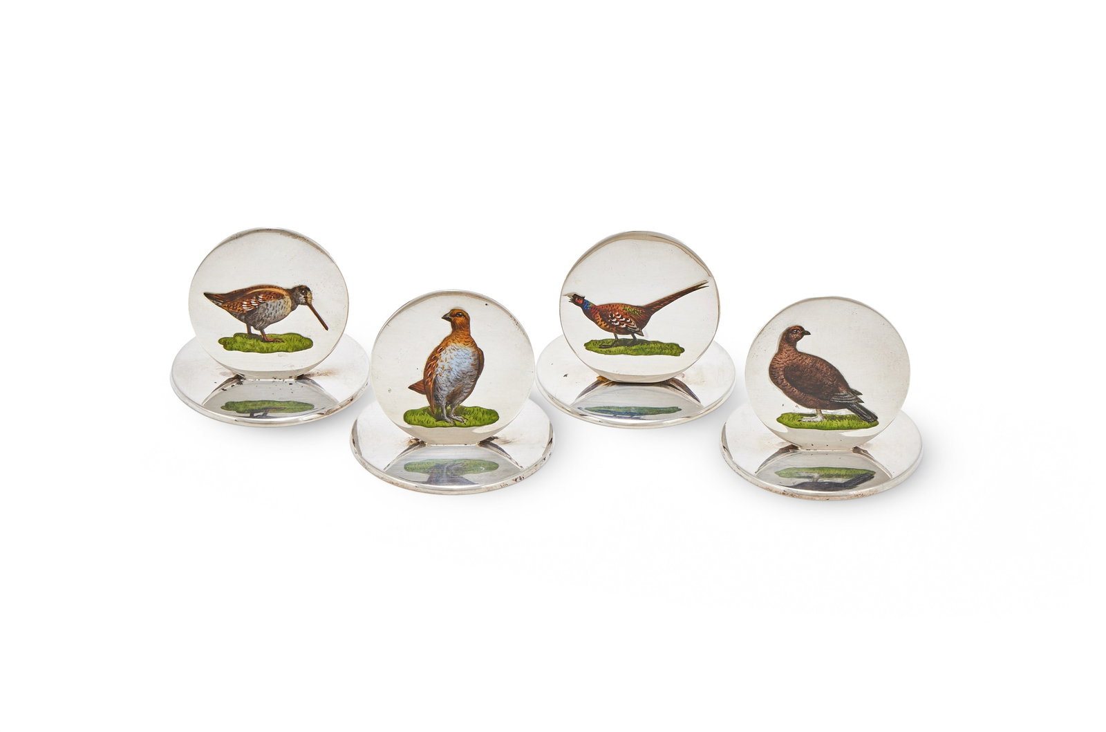 A CASED SET OF FOUR SILVER AND ENAMEL MENU HOLDERS, CHARLES PERRY & CO., CHESTER 1928: A CASED SET OF FOUR SILVER AND ENAMEL MENU HOLDERSCHARLES PERRY & CO., CHESTER 1928The circular panels each enamelled with a game bird and on circular bases4cm diameter137g (4.4 oz)