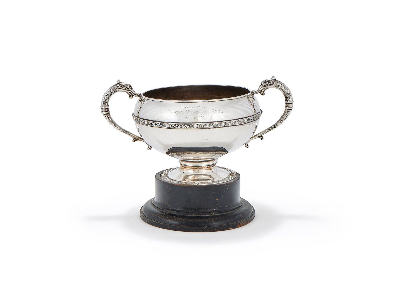 AN IRISH SILVER TWIN HANDLED TROPHY CUP, ALWRIGHT & MARSHALL LTD., DUBLIN 1930: AN IRISH SILVER TWIN HANDLED TROPHY CUPALWRIGHT & MARSHALL LTD., DUBLIN 1930With twin dolphin scroll handles, a Celtic band, engraved 'Presented by Martin Mahony & Bros. Blarney' and with a list of ra