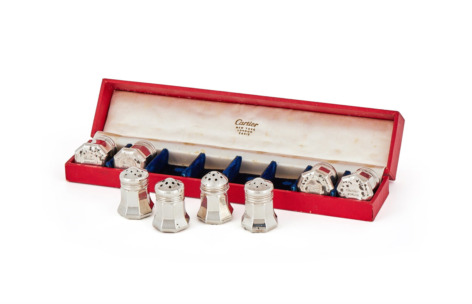 CARTIER, A CASED SET OF EIGHT AMERICAN SILVER SALT AND PEPPER SHAKERS, STAMPED STERLING: CARTIER, A CASED SET OF EIGHT AMERICAN SILVER SALT AND PEPPER SHAKERSSTAMPED STERLINGWith pierced domed covers and flared bodies4cm high61g (2 oz)