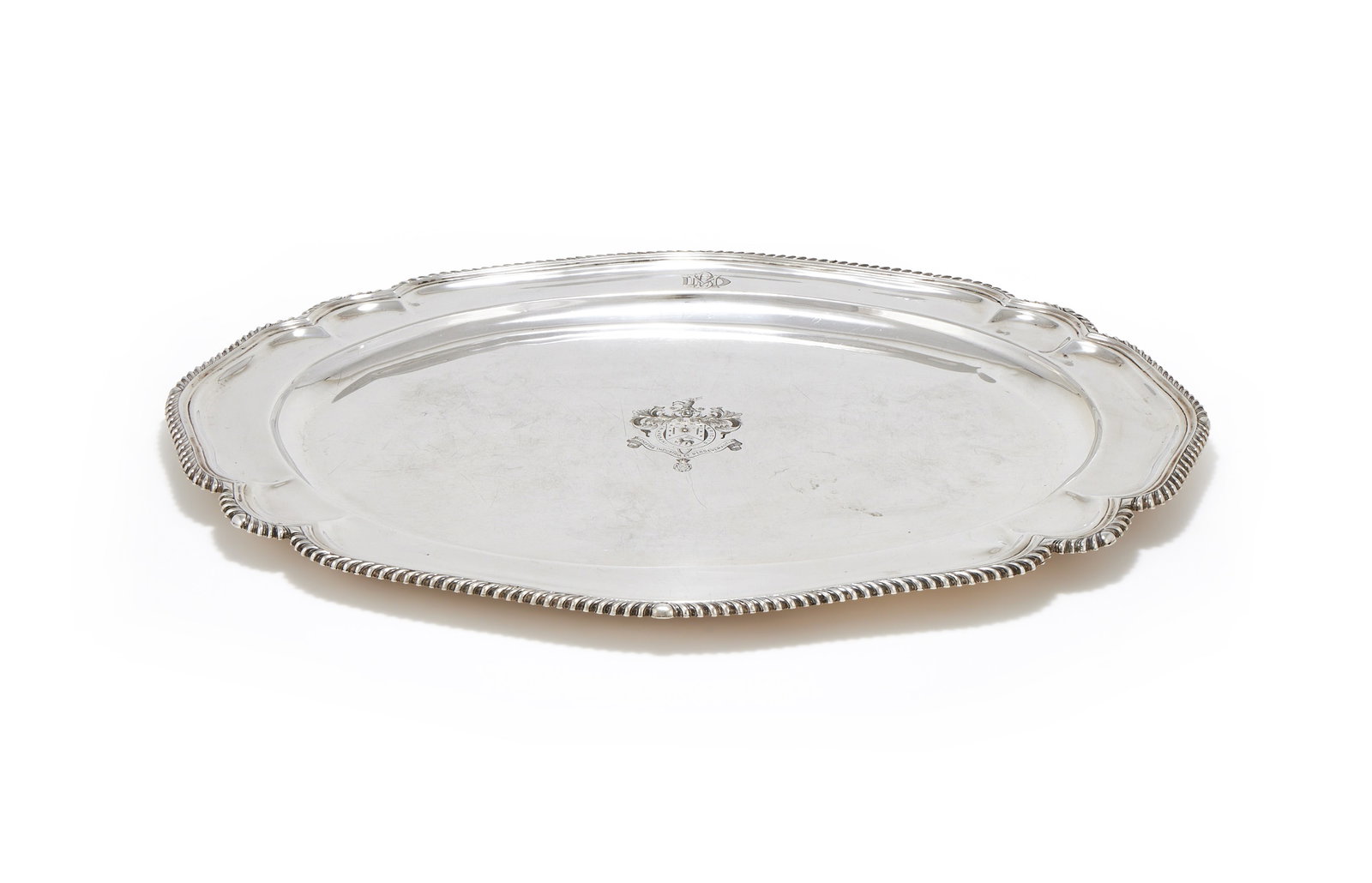 A SILVER SHAPED OVAL TRAY, MAKER'S MARK C.L.B., LONDON 1925: A SILVER SHAPED OVAL TRAYMAKER'S MARK C.L.B., LONDON 1925With a gadrooned border, engraved DMB and with an armorial64cm long3069g (98.7 oz)This is the armorial, honour ribbon and monogram of Maneckji 