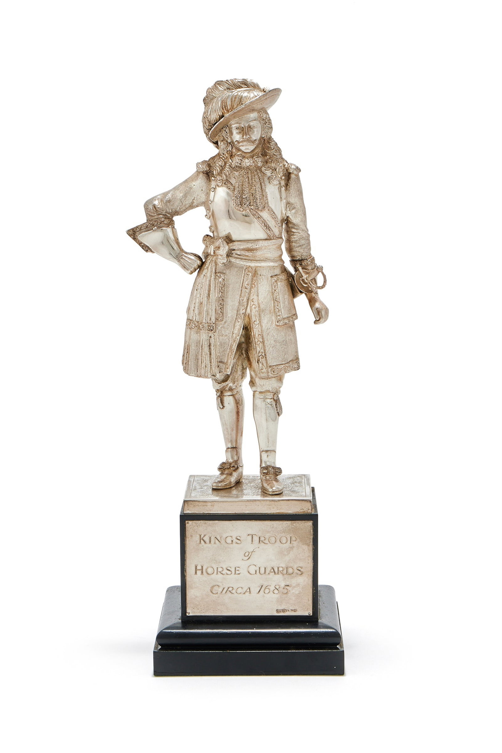 A SILVER FIGURE OF A DISMOUNTED HORSE GUARD OFFICER, CARRINGTON & CO., LONDON 1990: A SILVER FIGURE OF A DISMOUNTED HORSE GUARD OFFICERCARRINGTON & CO., LONDON 1990The Restoration Period Officer in full dress of circa 1660, on a black plinth with a plaque inscribed 'Kings Troop of Ho