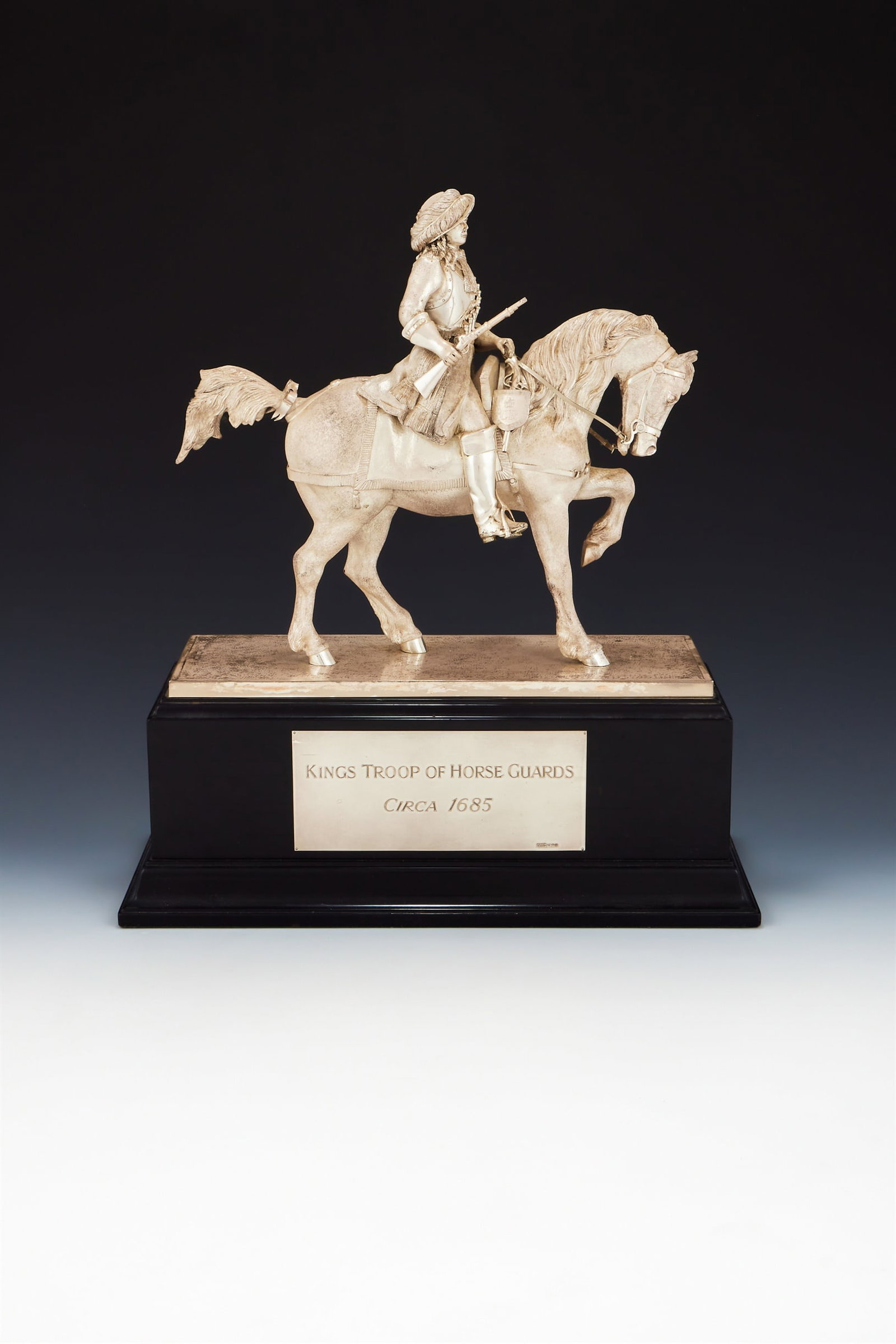 A SILVER FIGURE OF A KINGS TROOP OF HORSE GUARDS OFFICER, CARRINGTON & CO., LONDON 1991: A SILVER FIGURE OF A KINGS TROOP OF HORSE GUARDS OFFICERCARRINGTON & CO., LONDON 1991The Restoration Period Officer in full dress of circa 1660 on horseback, on a black rectangular plinth with plaque 