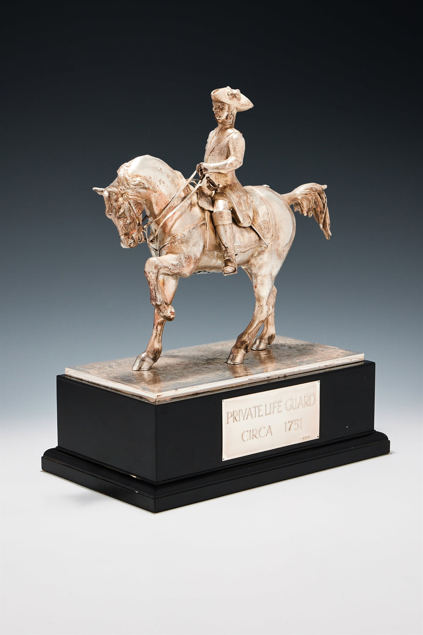 A SILVER FIGURE OF AN EQUESTRIAN LIFE GUARD, CARRINGTON & CO., LONDON 1997: A SILVER FIGURE OF AN EQUESTRIAN LIFE GUARDCARRINGTON & CO., LONDON 1997The George II Period Officer in full dress of circa 1750 on horseback, on a rectangular black plinth inscribed 'Private Life Gua