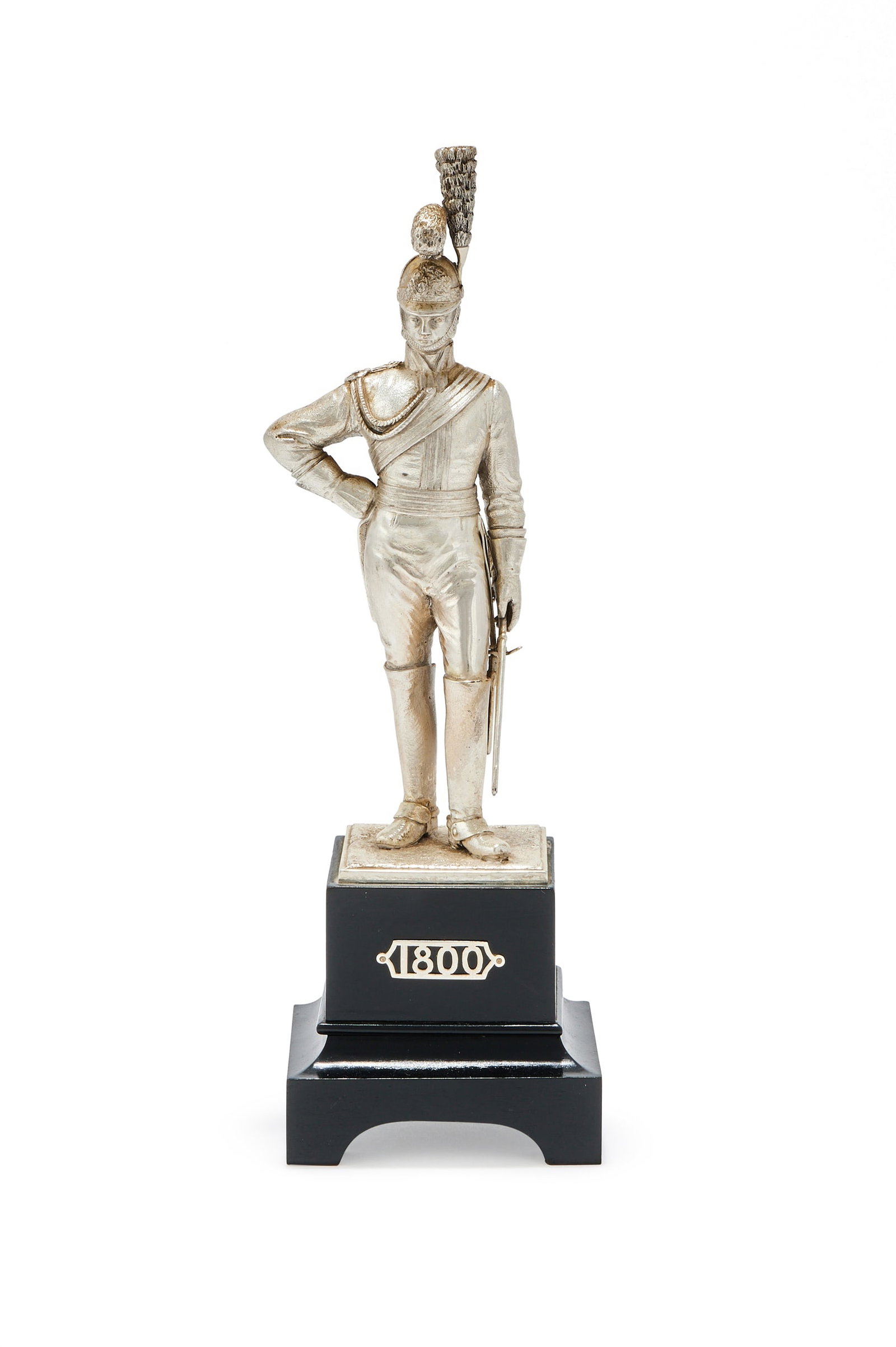 A SILVER FIGURE OF A LIFE GUARD, CARRINGTON & CO., LONDON 1973: A SILVER FIGURE OF A LIFE GUARDCARRINGTON & CO., LONDON 1973The George III Period Officer in full dress of circa 1800, on a black wood plinth applied with 180029cm high including the plinthProvenance: