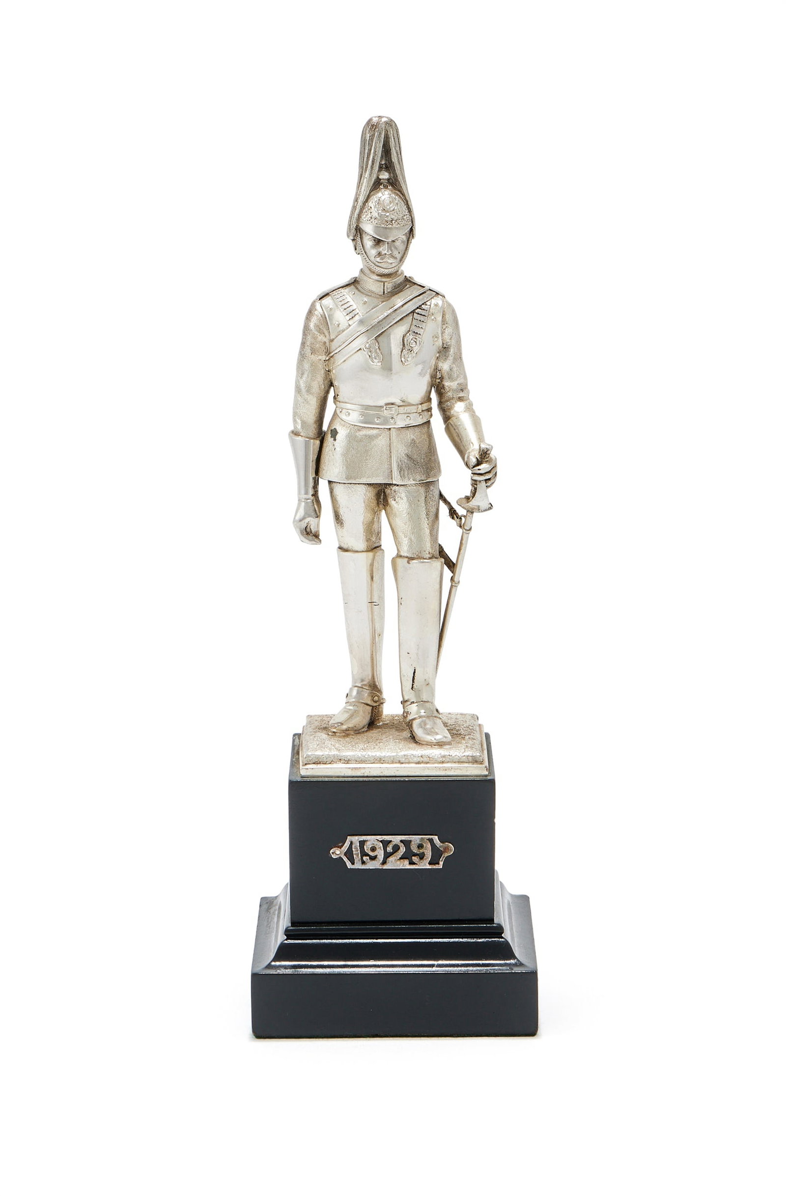 A SILVER FIGURE OF A LIFE GUARD, CARRINGTON & CO., LONDON 1928: A SILVER FIGURE OF A LIFE GUARDCARRINGTON & CO., LONDON 1928The George V Period Officer in state dress of circa 1930, on a black plinth applied with 192927.5cm high including the plinthProvenance:A Pr