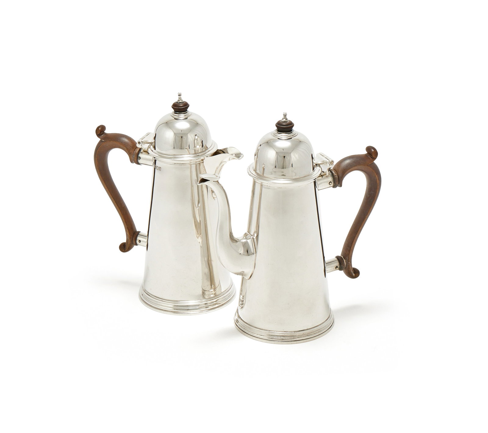 A SILVER TAPERING COFFEE POT AND HOT WATER POT, RICHARD COMYNS, LONDON 1956 AND 1958: A SILVER TAPERING COFFEE POT AND HOT WATER POTRICHARD COMYNS, LONDON 1956 AND 1958With compressed wood finials to the domed covers and wood scroll handles14cm high1566g (50.35 oz) gross