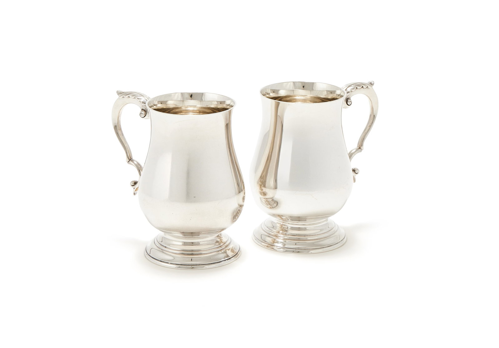 A PAIR OF SILVER BALUSTER TANKARDS, WAKELY & WHEELER, LONDON 1964: A PAIR OF SILVER BALUSTER TANKARDSWAKELY & WHEELER, LONDON 1964With leaf capped double scroll handles and on circular moulded spreading feet14cm high1081g (34.75 oz)