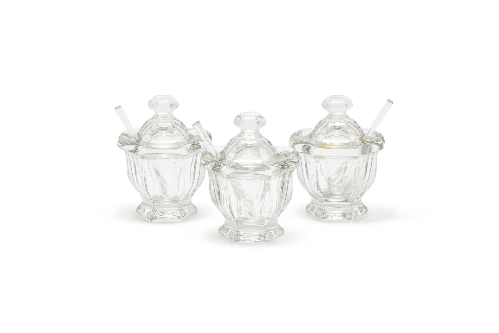 BACCARAT, HARCOURT MISSOURI, THREE CRYSTAL JAM/MUSTARD JARS AND SPOONS: BACCARAT, HARCOURT MISSOURITHREE CRYSTAL JAM/MUSTARD JARS AND SPOONSWith hexagonal bodies, bevelled collars and covers, each with a serving spoonAcid etched marks11.5cm high