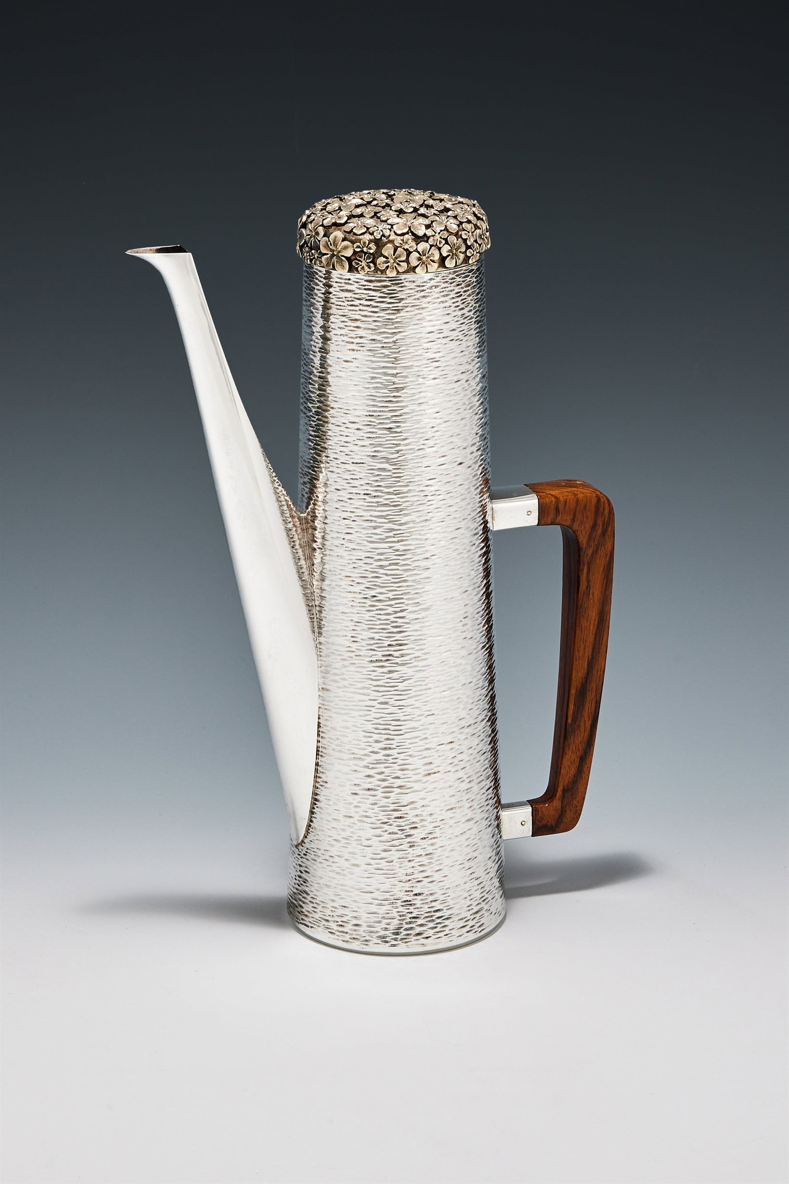 Y STUART DEVLIN, A SILVER GILT TAPERING COFFEE POT, LONDON 1979: Y STUART DEVLINA SILVER GILT TAPERING COFFEE POT, LONDON 1979The cover with a spray of flower heads, the textured body with a rosewood handle28cm high997g (32.05 oz) grossProvenance:A Private Collecti
