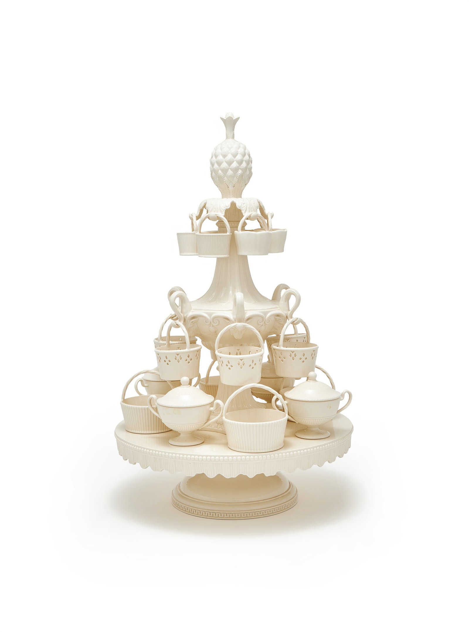 A WEDGWOOD CREAMWARE (QUEEN'S WARE) EPERGNE, LATE 20TH CENTURY: A WEDGWOOD CREAMWARE (QUEEN'S WARE) EPERGNELATE 20TH CENTURYSurmounted with a pineapple finial, the upper section with arms suspending baskets, the lower tier with freestanding baskets and urns, 60cm 