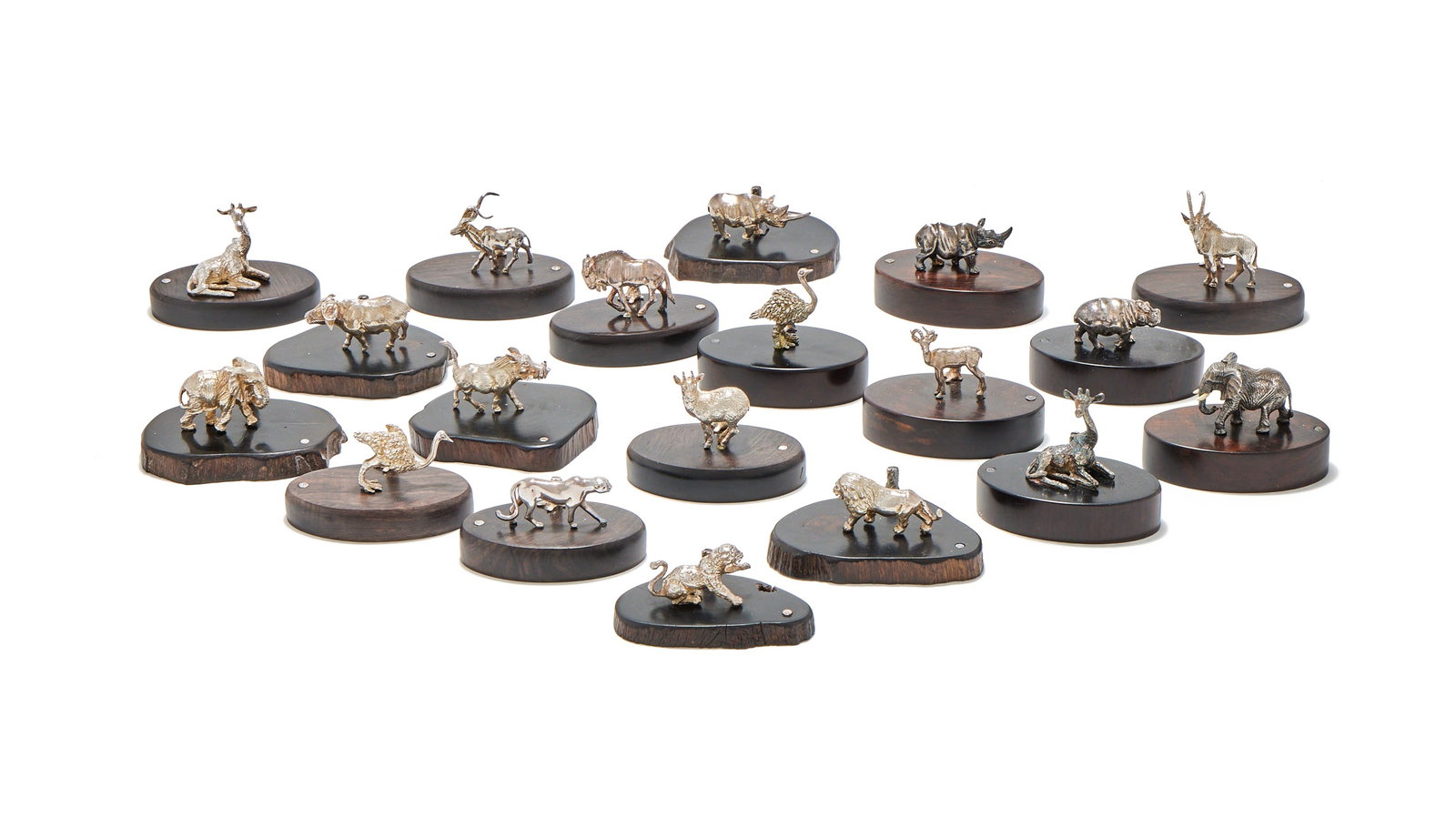 PATRICK MAVROS, NINETEEN SILVER ANIMAL MENU HOLDERS, ZIMBABWE, MODERN: PATRICK MAVROS, NINETEEN SILVER ANIMAL MENU HOLDERSZIMBABWE, MODERNEach mounted on an ebonized base with a tree stumpThe bases from 6cm to 7cm longWith a Patrick Mavros card box and care guide