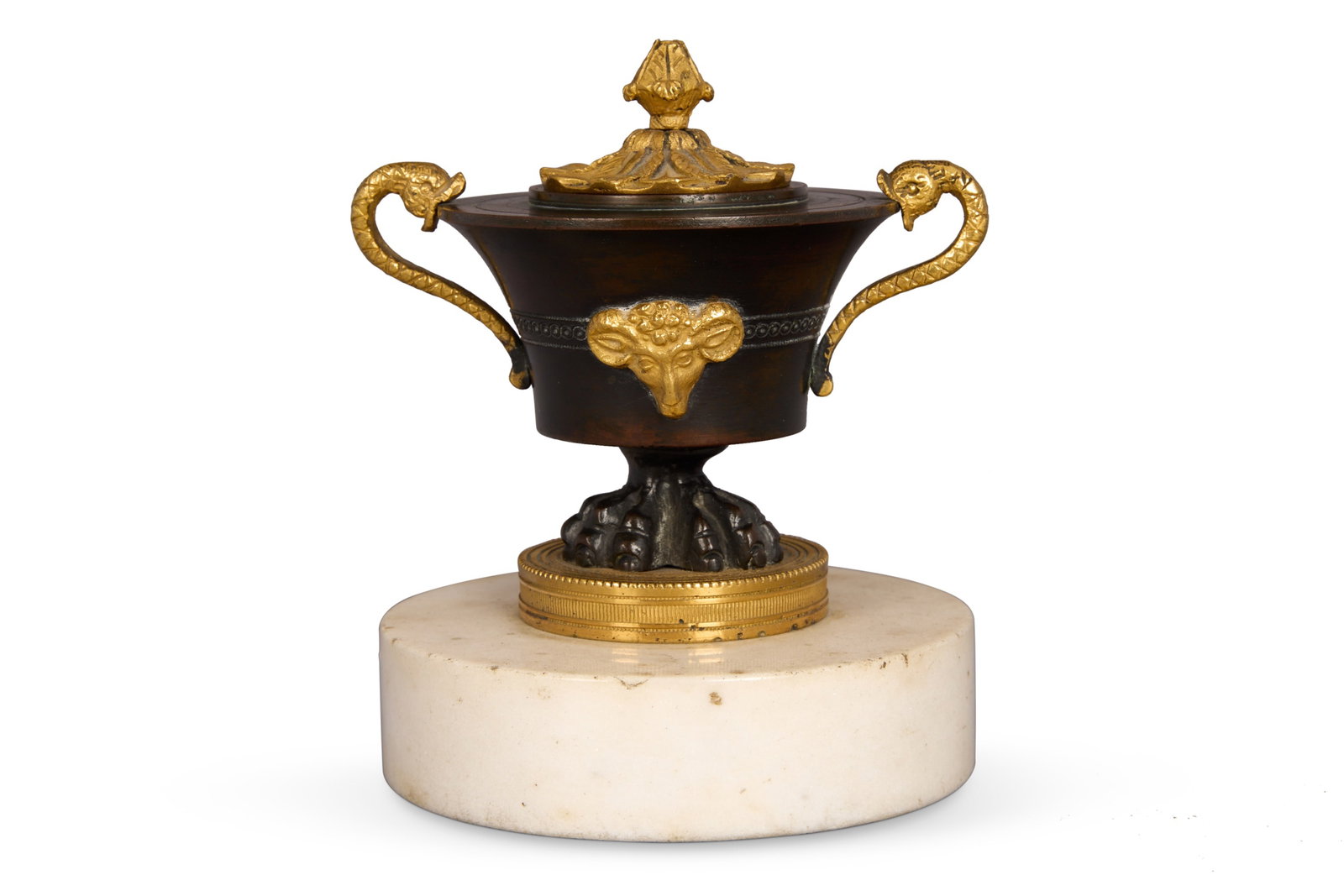 AN ORMOLU MOUNTED PATINATED BRONZE 'INKSTAND', ATTRIBUTED TO VULLIAMY, EARLY 19TH CENTURY: AN ORMOLU MOUNTED PATINATED BRONZE 'INKSTAND'ATTRIBUTED TO VULLIAMY, EARLY 19TH CENTURYSet on a white marble drum plinth11cm highNote the inkstand decorated with sphynxes supplied in 1810 to George, P