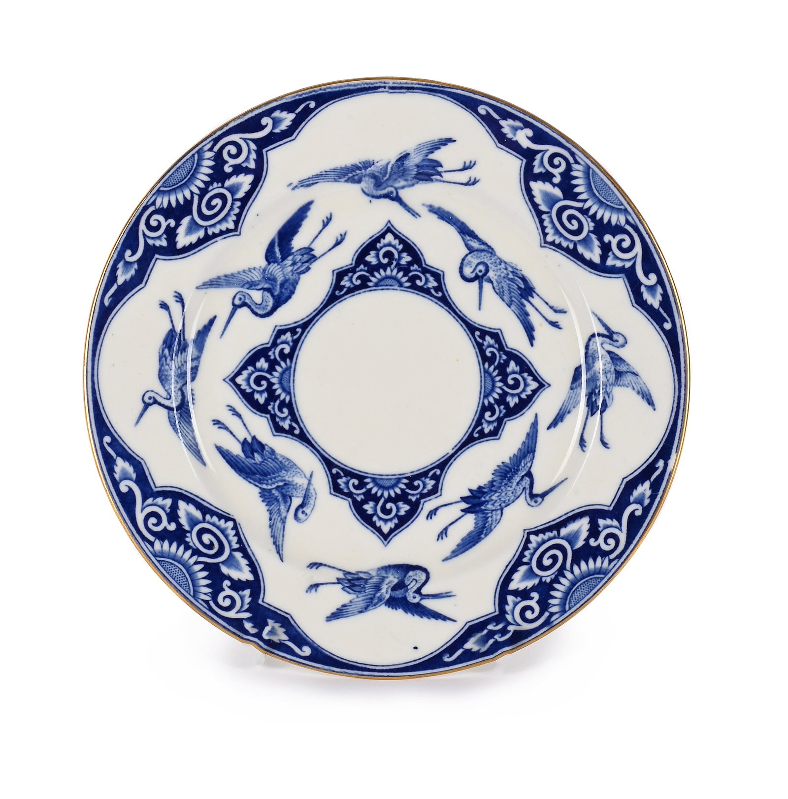 BROWNFIELD & SONS (ENGLISH), 'FLYING CRANE' PLATE, CIRCA 1890: BROWNFIELD & SONS (ENGLISH)'FLYING CRANE' PLATE, CIRCA 1890Glazed porcelain, blue decoration of cranes and floral motifs, gilt rimMaker's marks impressed to underside with '9/77' and gilt '11.28 0'20c