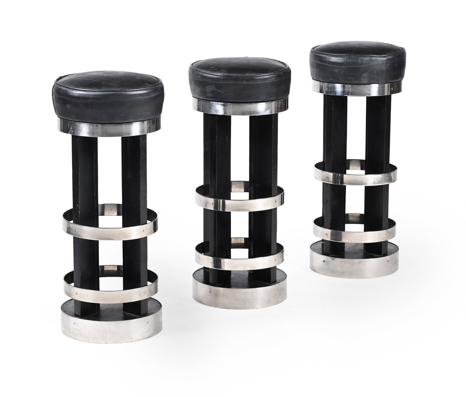 THREE AMERICAN BARSTOOLS, CIRCA 1950: AMERICANTHREE BARSTOOLS, CIRCA 1950Chromed metal, ebonised wood, leather upholstery, swivel tops 79cm high, 32cm diameter