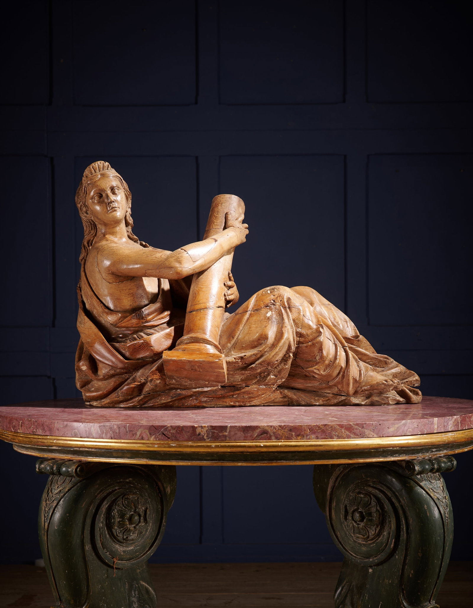 A GEORGE III CARVED PINE FEMALE FIGURE, EMBLEMATIC OF ARCHITECTURE: A GEORGE III CARVED PINE FEMALE FIGUREEMBLEMATIC OF ARCHITECTURECIRCA 181055cm high, 78cm wideProvenance:Selected contents from a Private Collection, Hampshire
